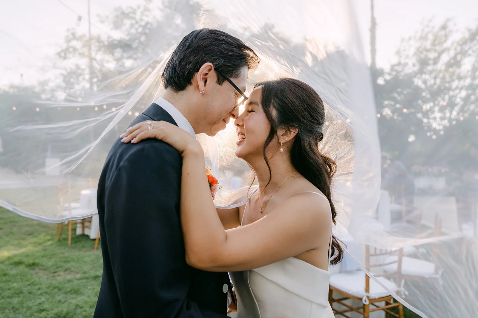 A golden-hour kiss beneath the veil