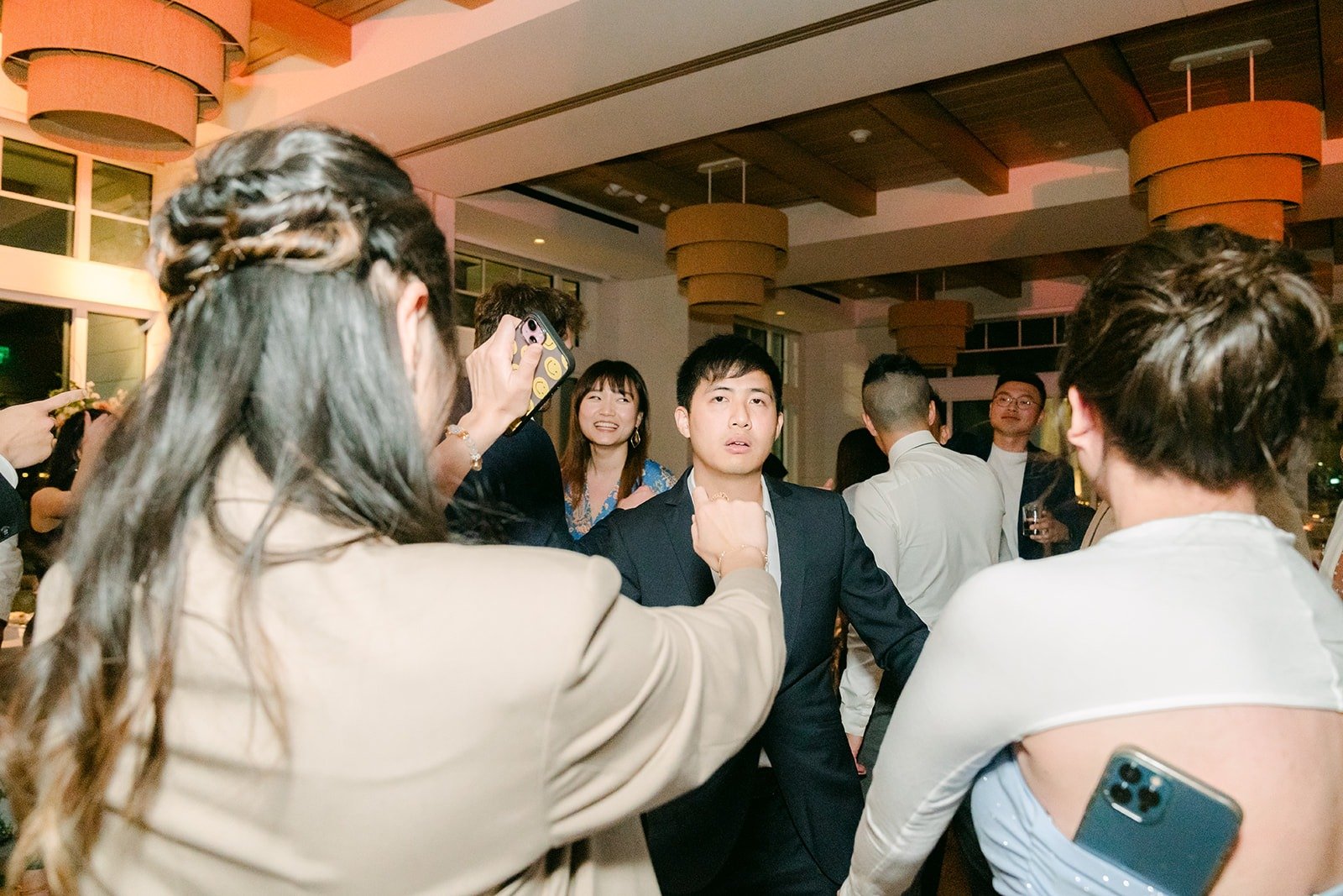 Guests with their arms up on the dance floor