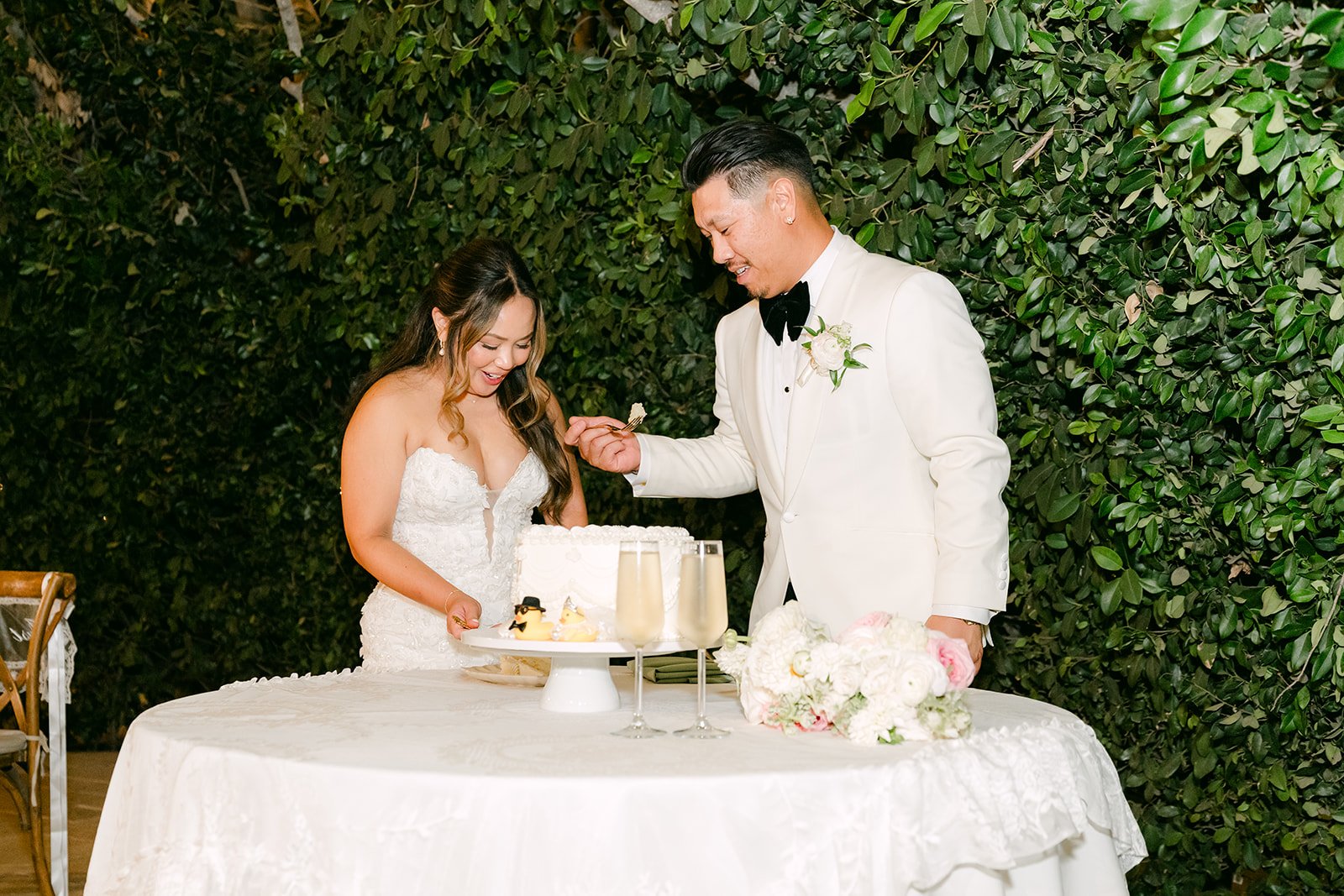 Nicole and Caryl cutting their wedding cake to L-O-V-E by Joss Stone.