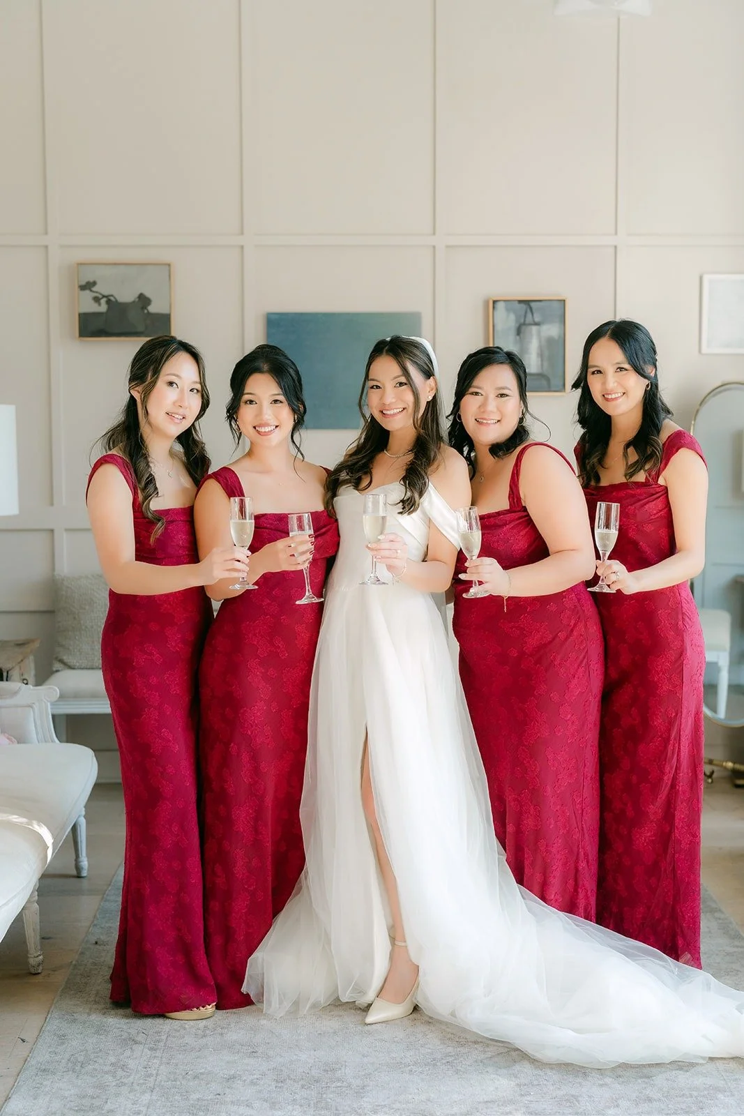Jadee with her bridesmaids in burgundy in the bridal suite, photographed by One and Only Production