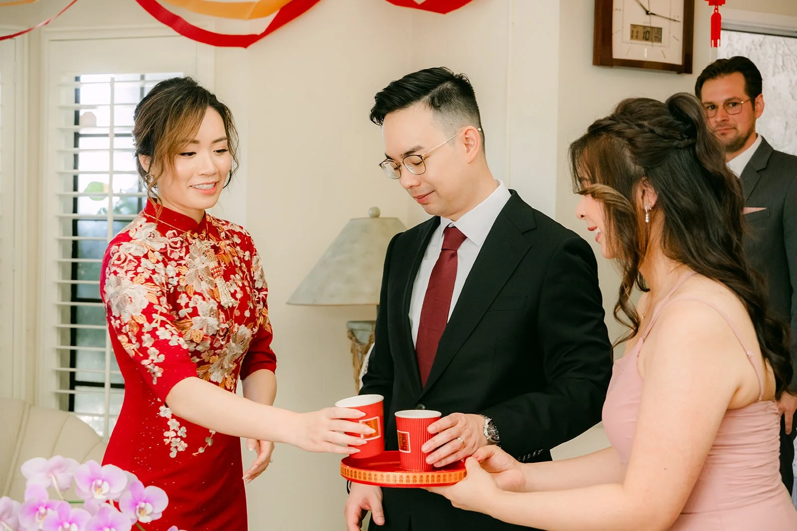 Pauline and Ken serving tea to a relative.