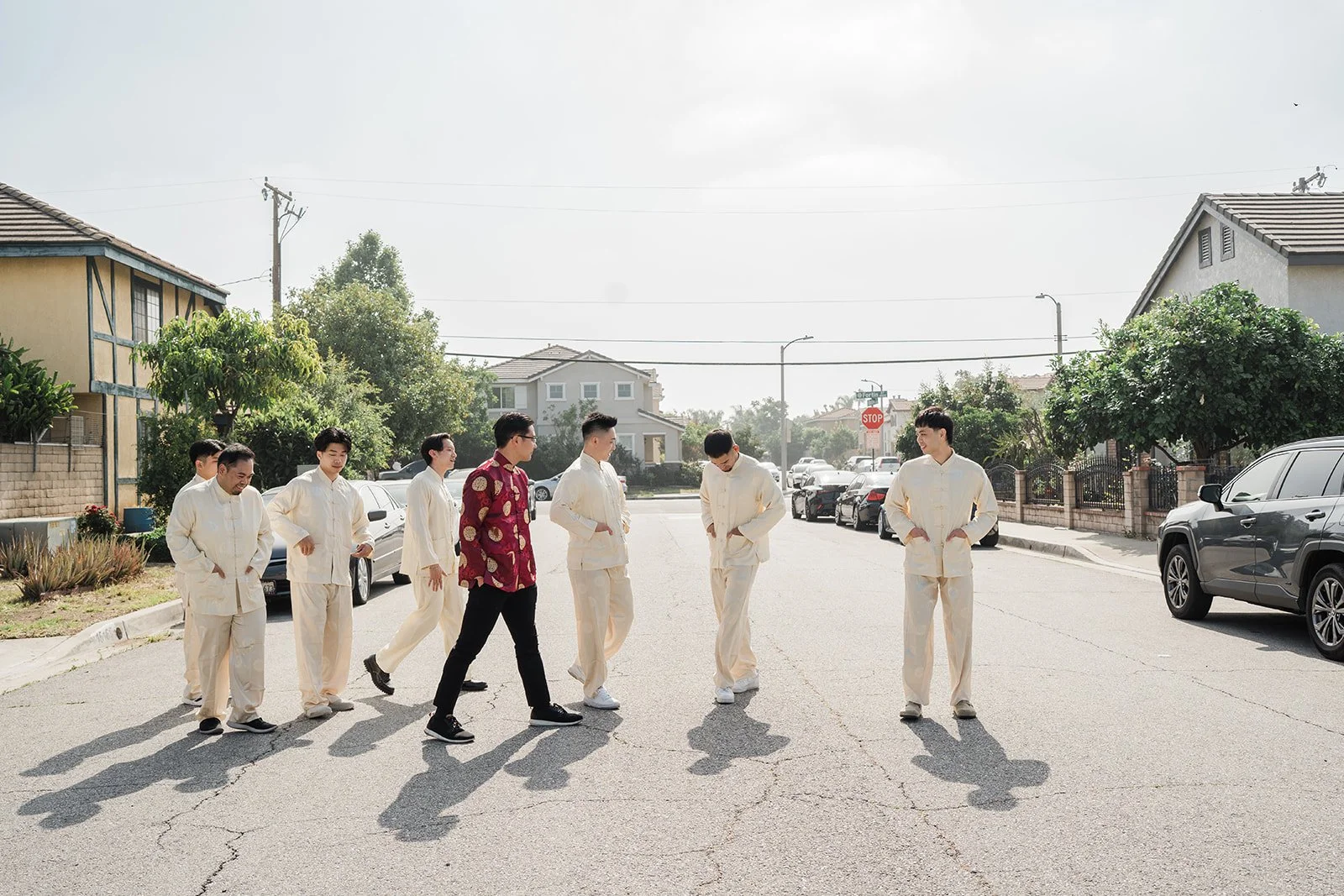 Danny and his groomsmen in cream suits on the street.