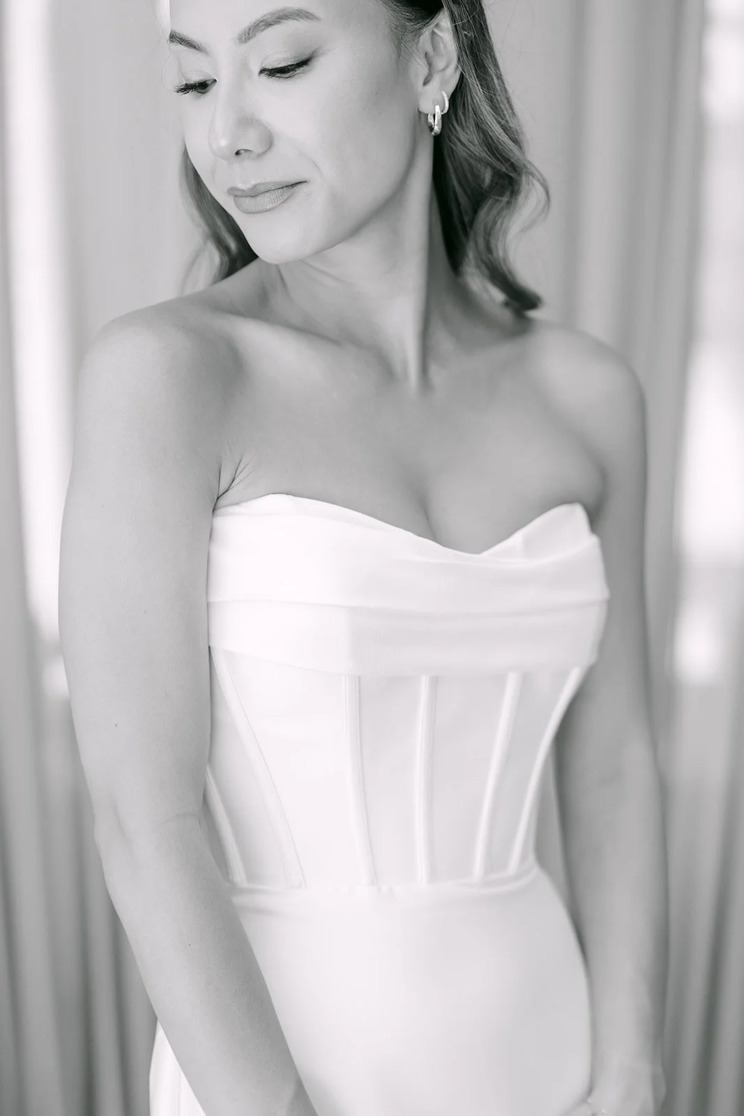 Black and white portrait of the bride in her strapless corset gown