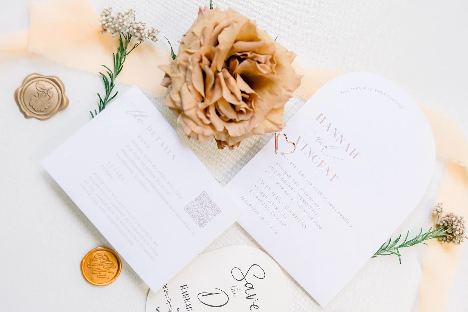 Hannah and Vincent's invitation suite with a dried rose and gold wax seals