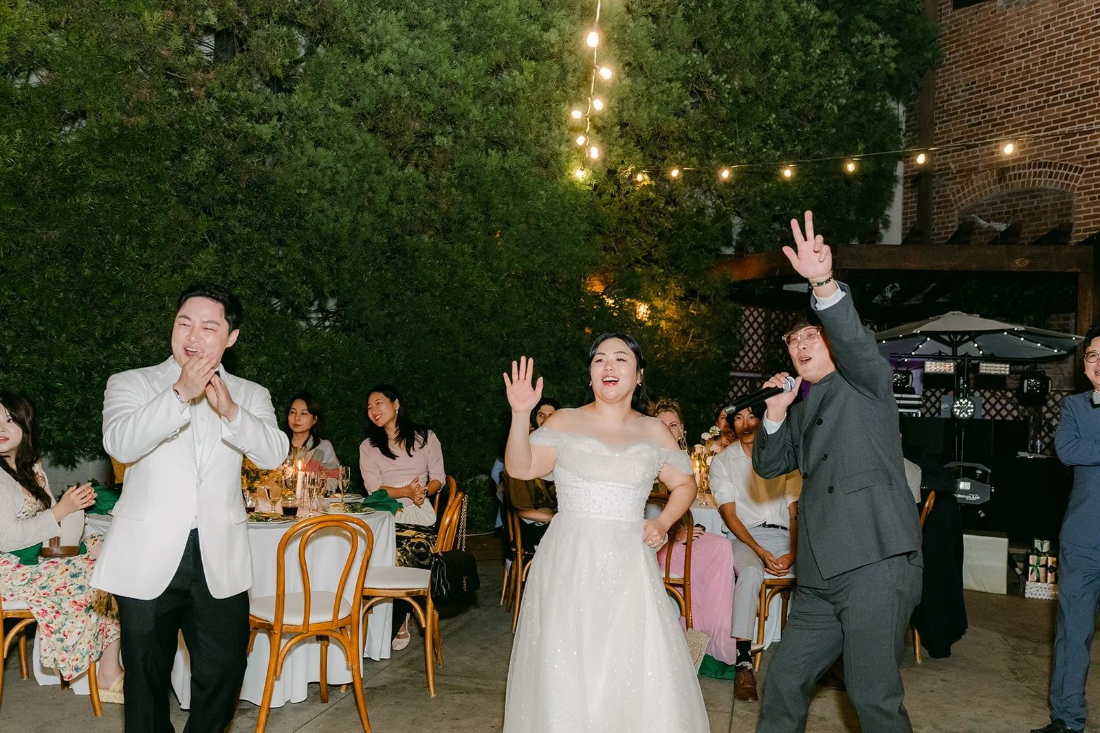 Chorok and Min Soo dancing with guests under the string lights