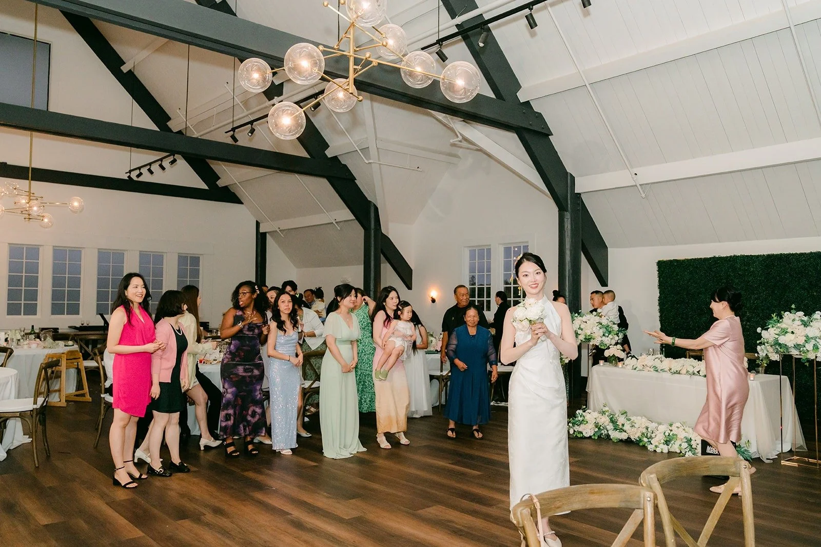 Guests gathering for the bouquet toss
