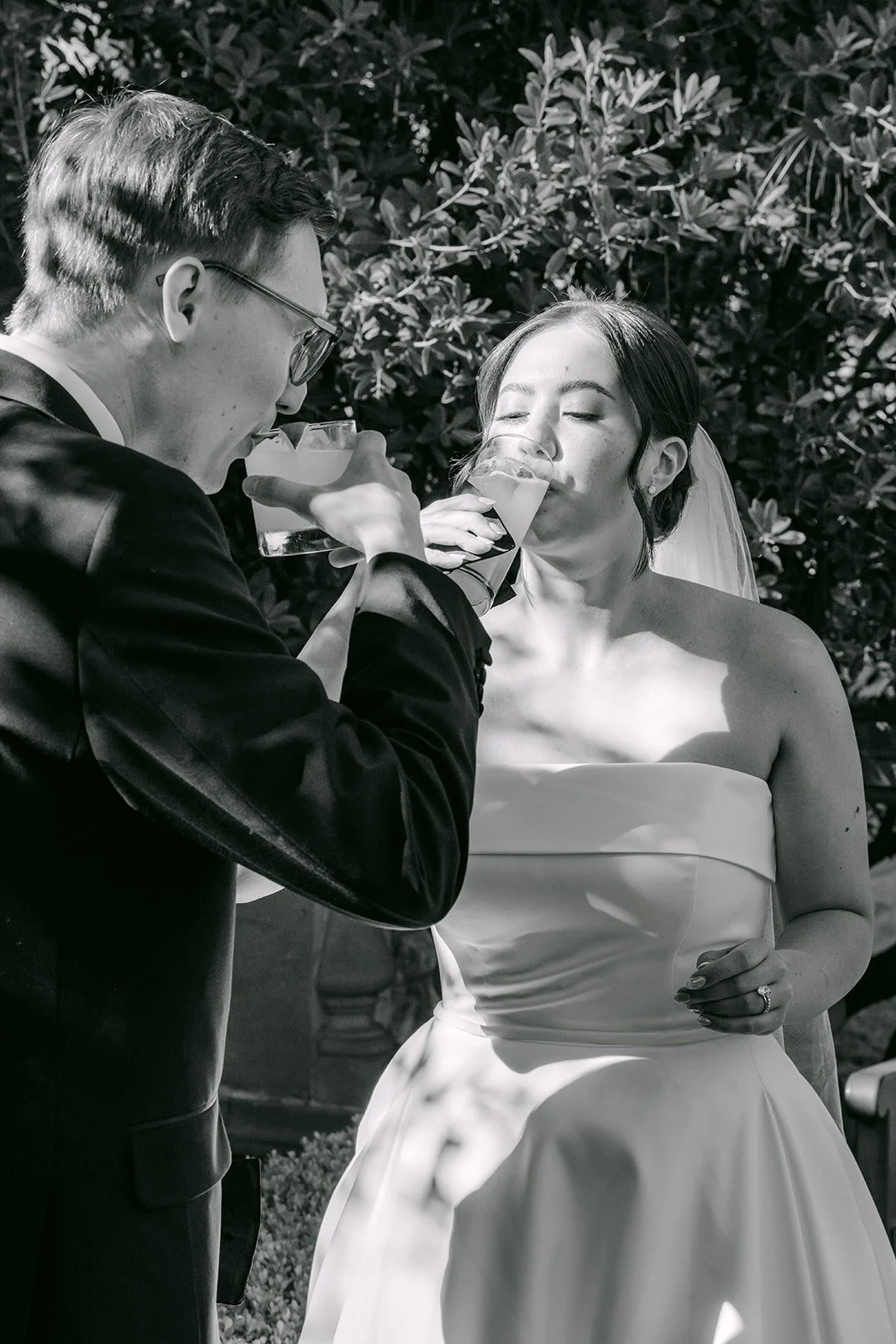 Black and white of Brianna and Nik sharing a toast
