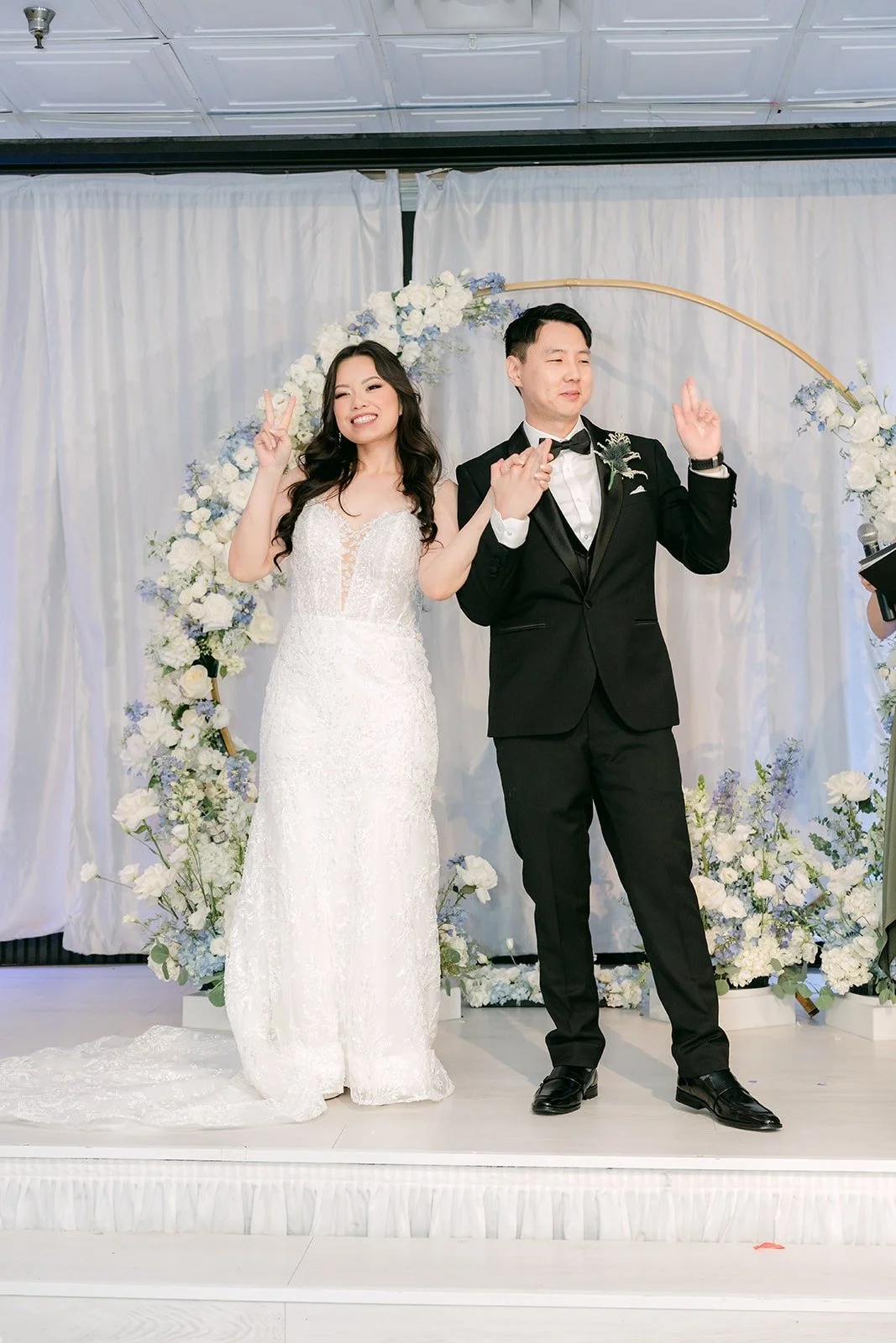 Emily and James cheering at the end of the ceremony, photographed by One and Only Production