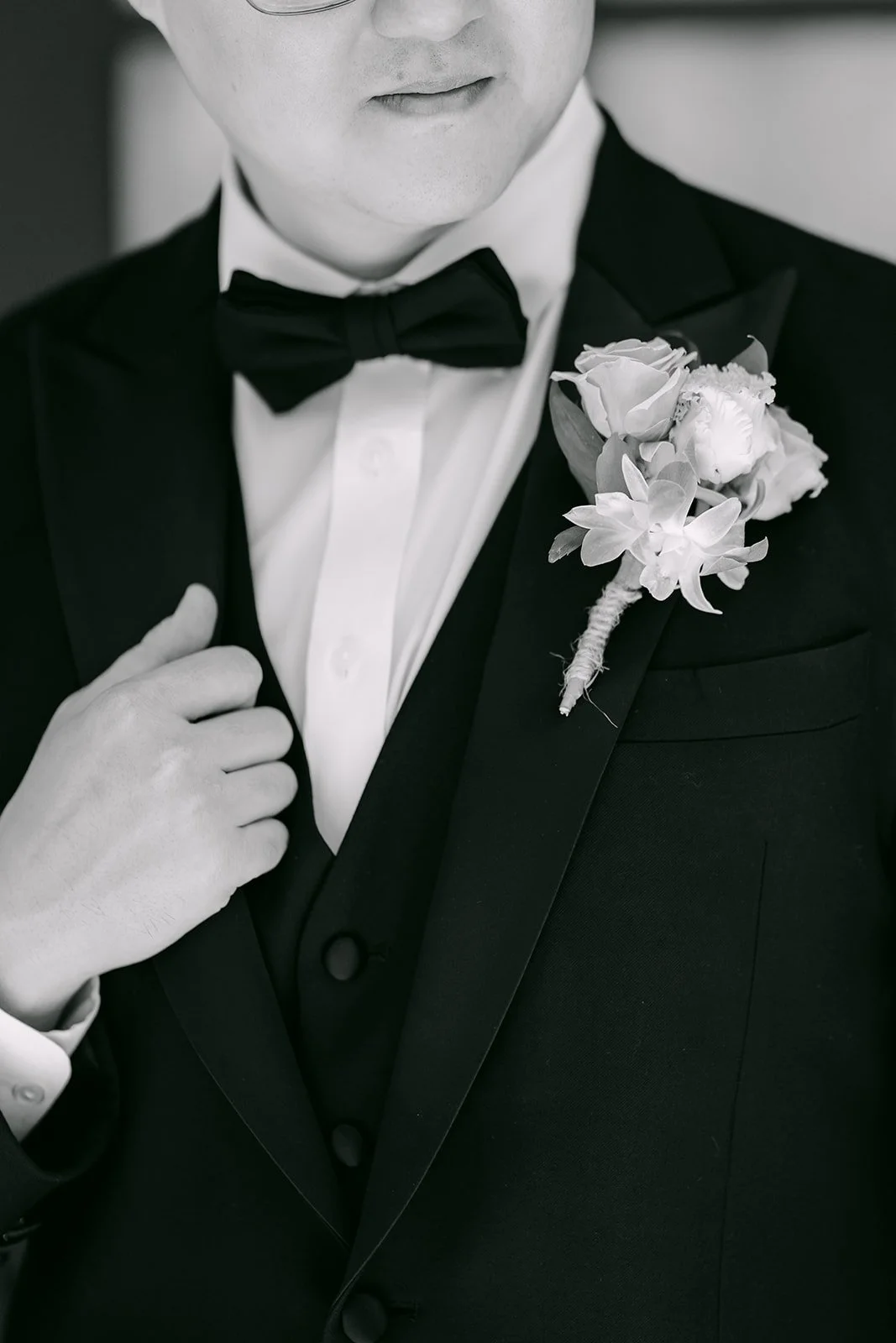 Joshua's white boutonniere on his tuxedo