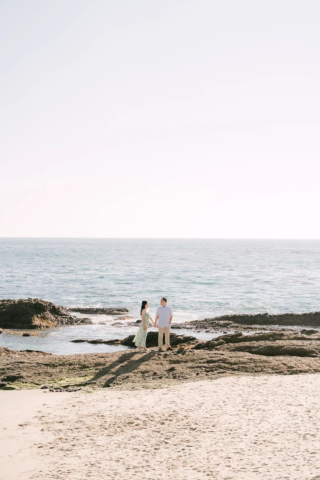 Constance and Lawrence on the rocks by the ocean.