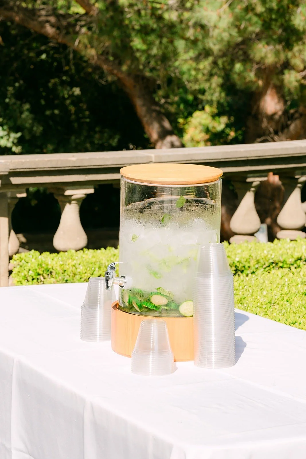 Lemonade dispenser and glasses on the drink table
