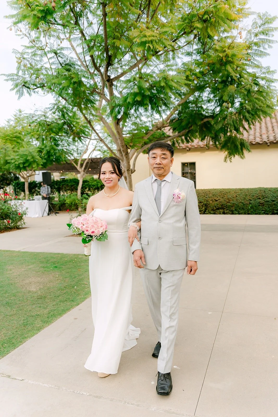 Ivy walking down the aisle in her off the shoulder gown