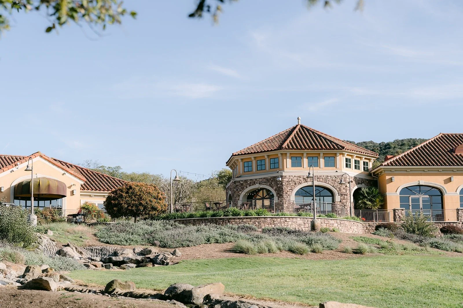 The Spanish style clubhouse at Los Robles Greens on a sunny spring afternoon
