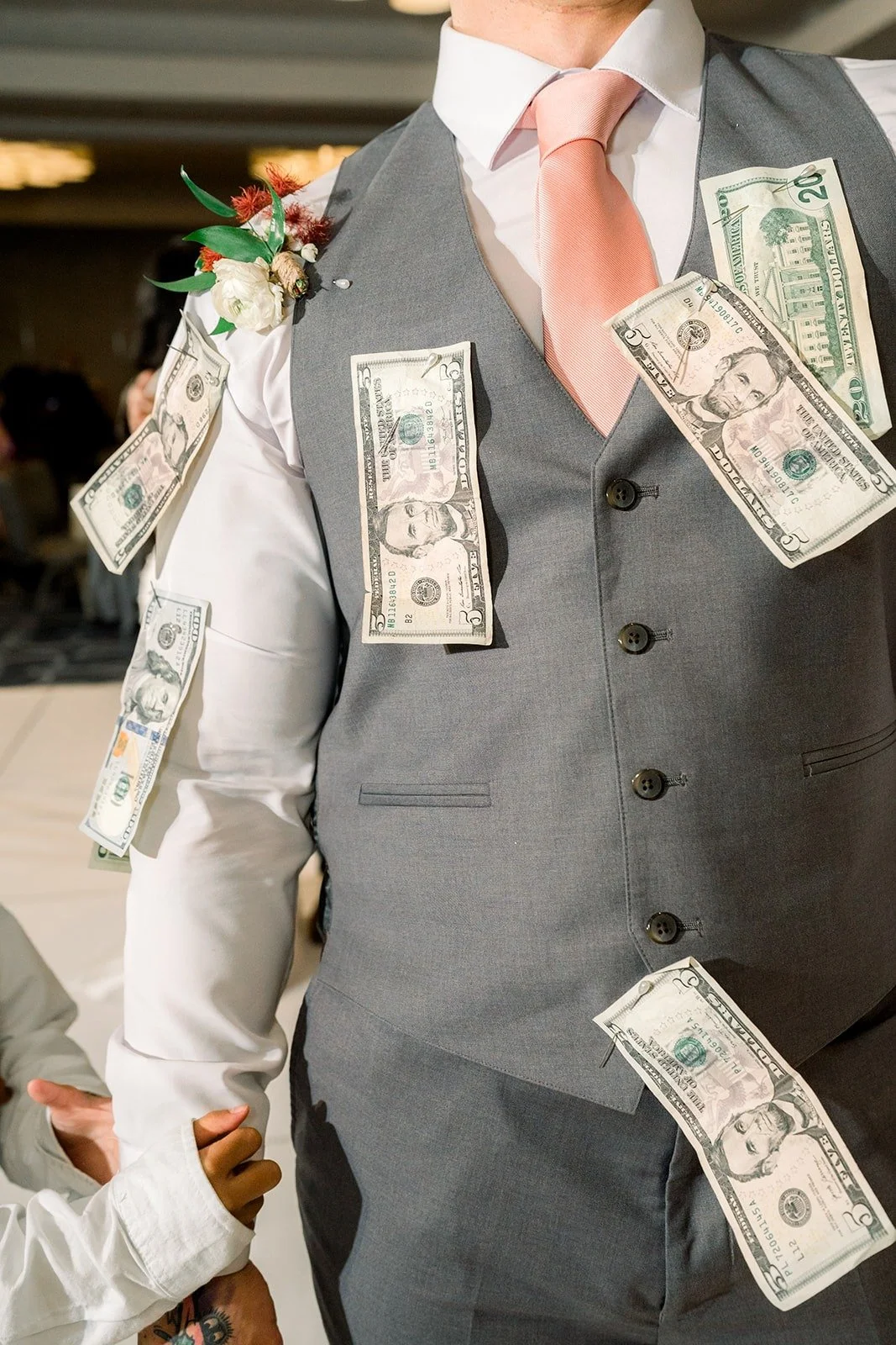 Dollar bills pinned to Mikey's vest, photographed by One and Only Production