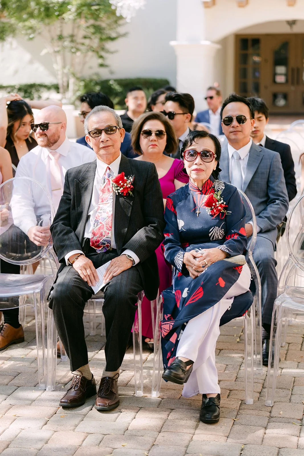 Guests laughing in their seats in the courtyard