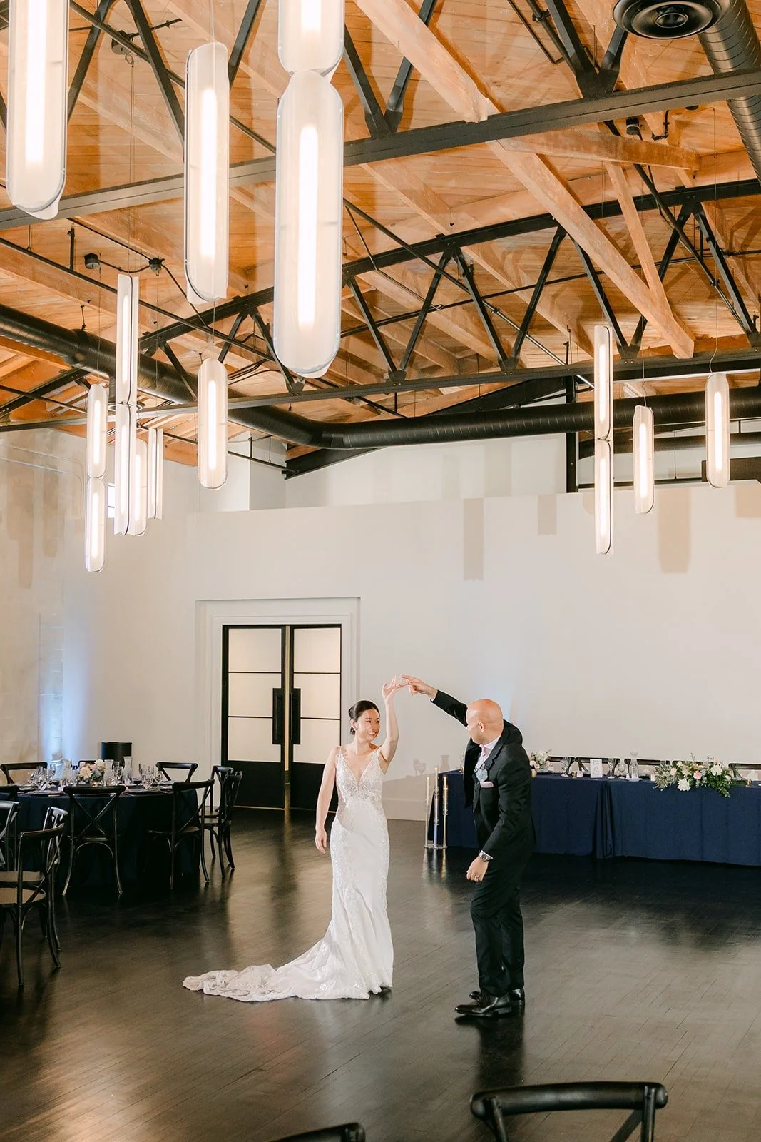 Brandon twirls Elisa across the empty dance floor
