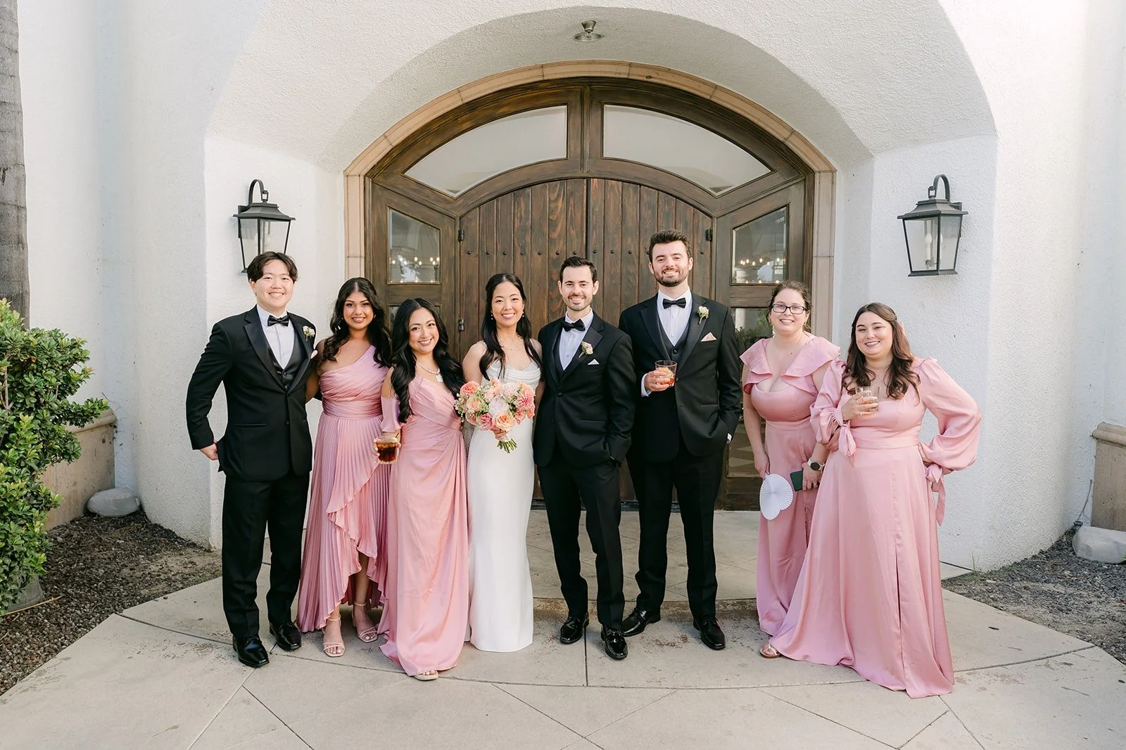 The wedding party lined up at the arched doors before the grand entrance
