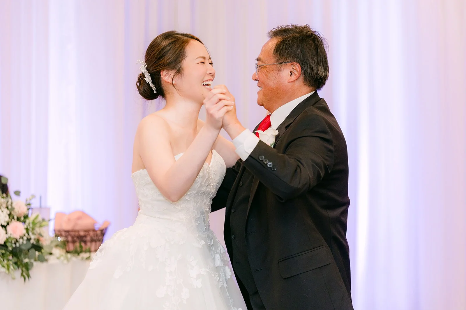 Victoria smiling at her dad during their dance