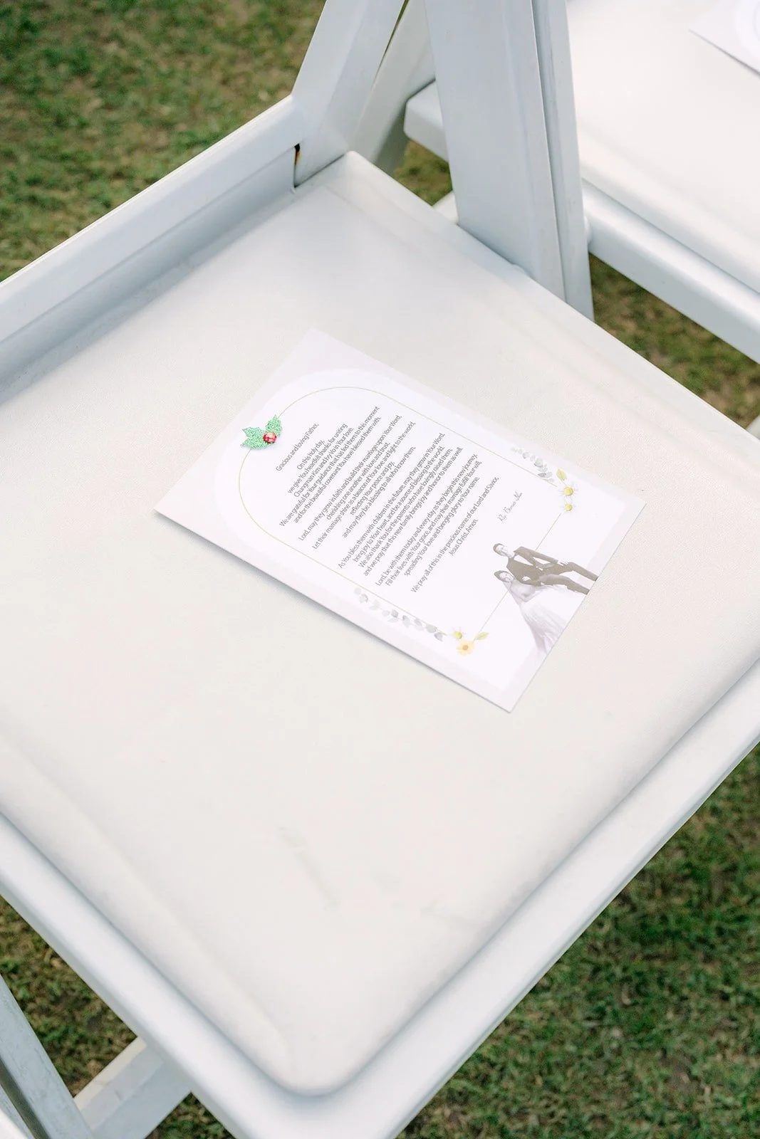 Ceremony program on a white folding chair
