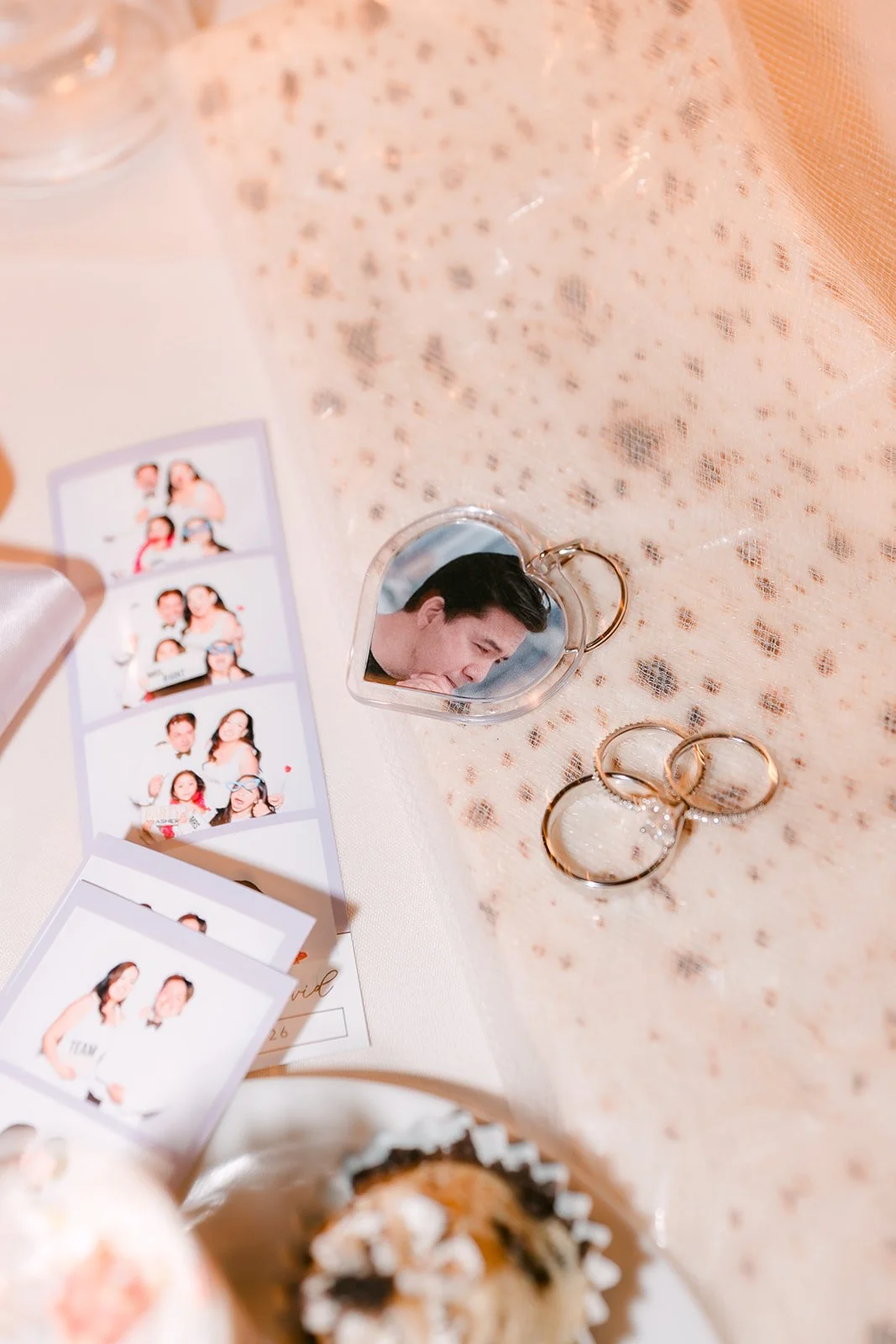 Photo strips and wedding bands at the sweetheart table