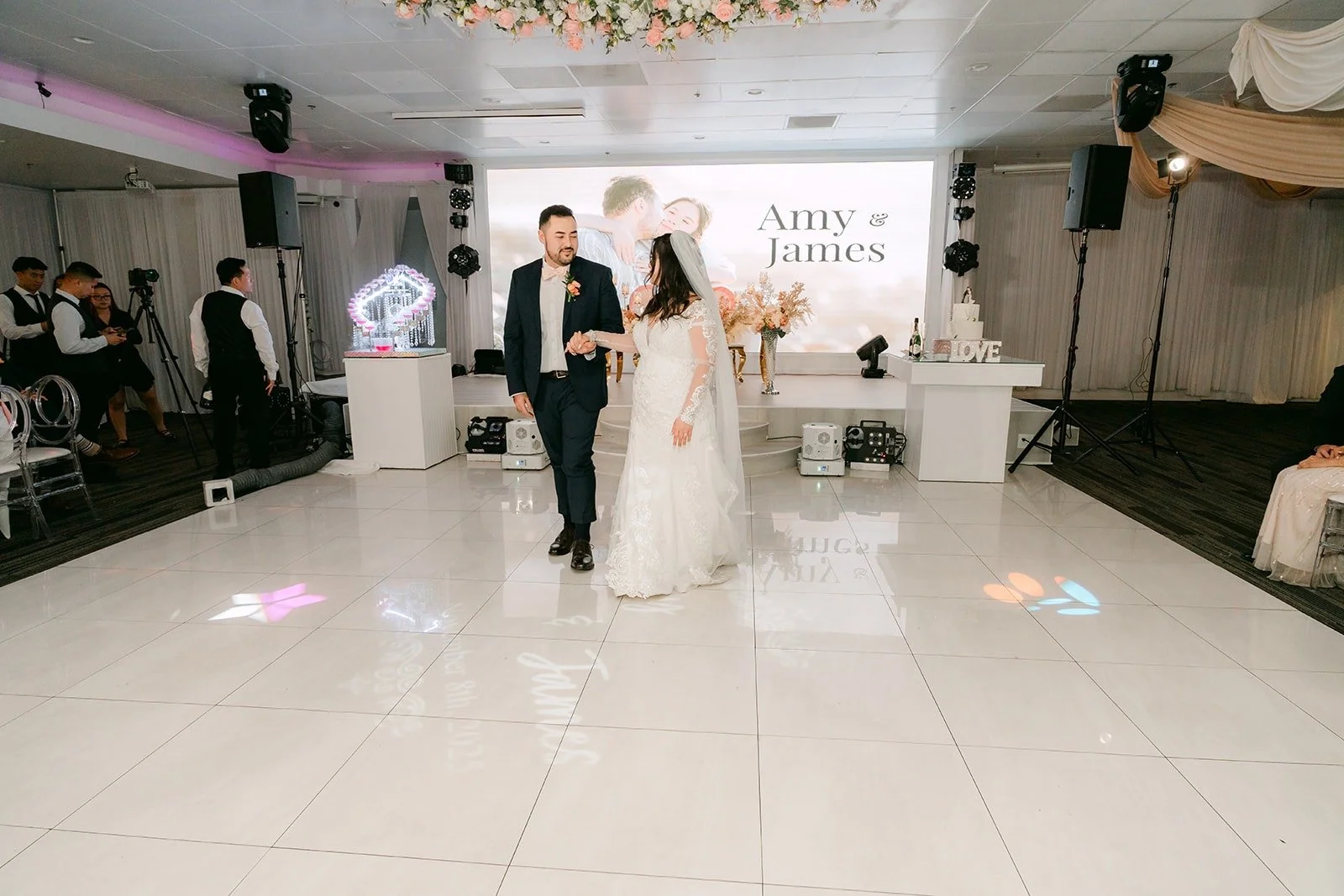 Amy and James entering the reception hall to applause