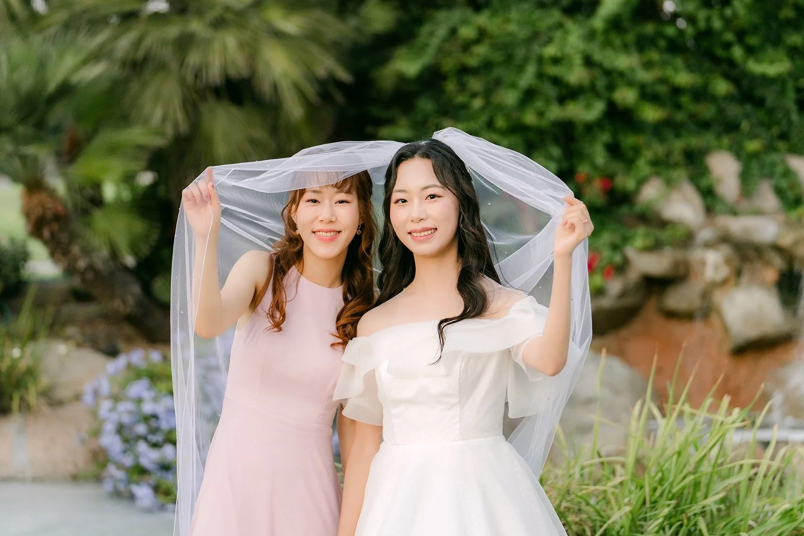Jeannie and her sister sharing a sweet moment under the veil, photographed by One and Only Production
