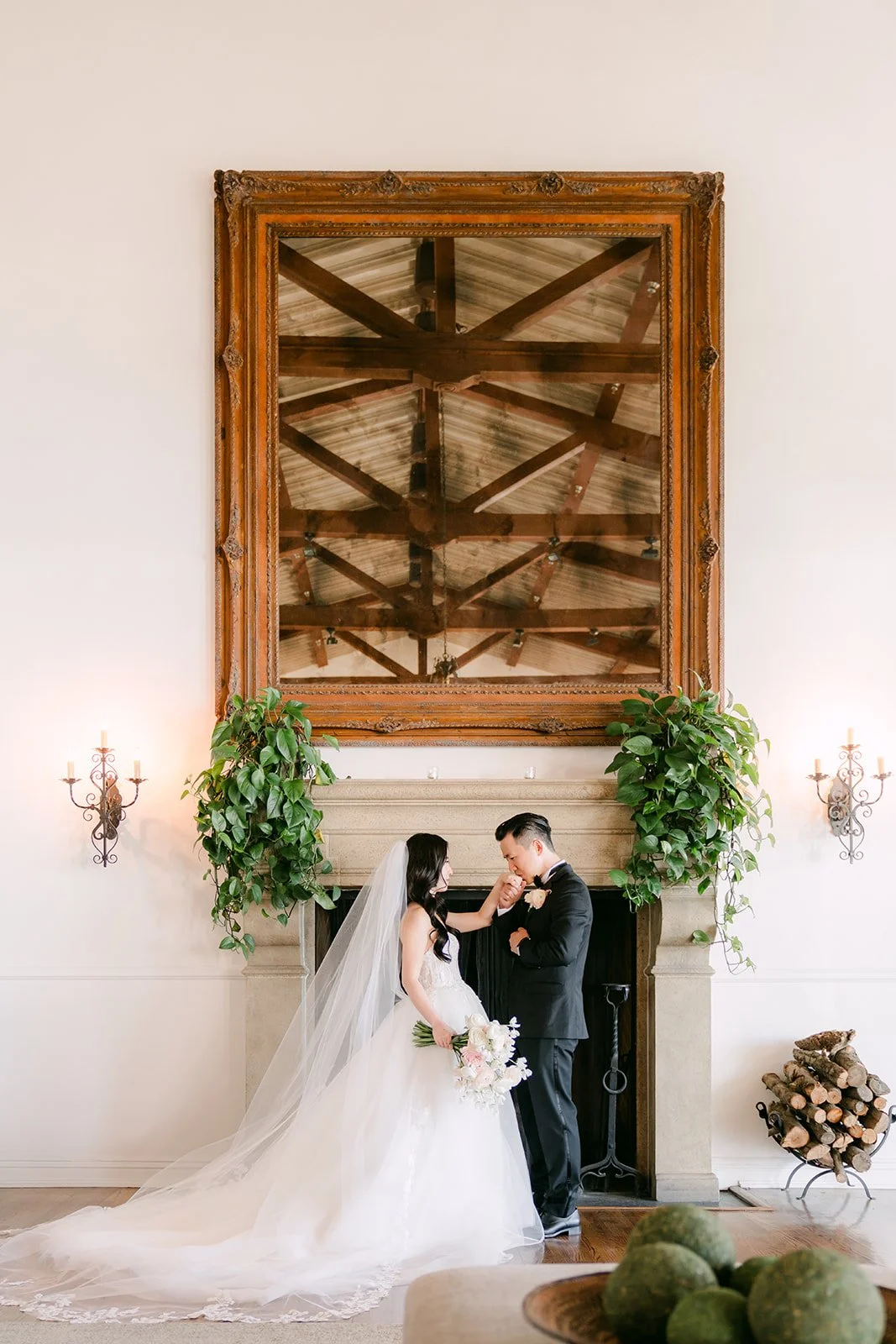 Kai kissing Kelley in front of the fireplace