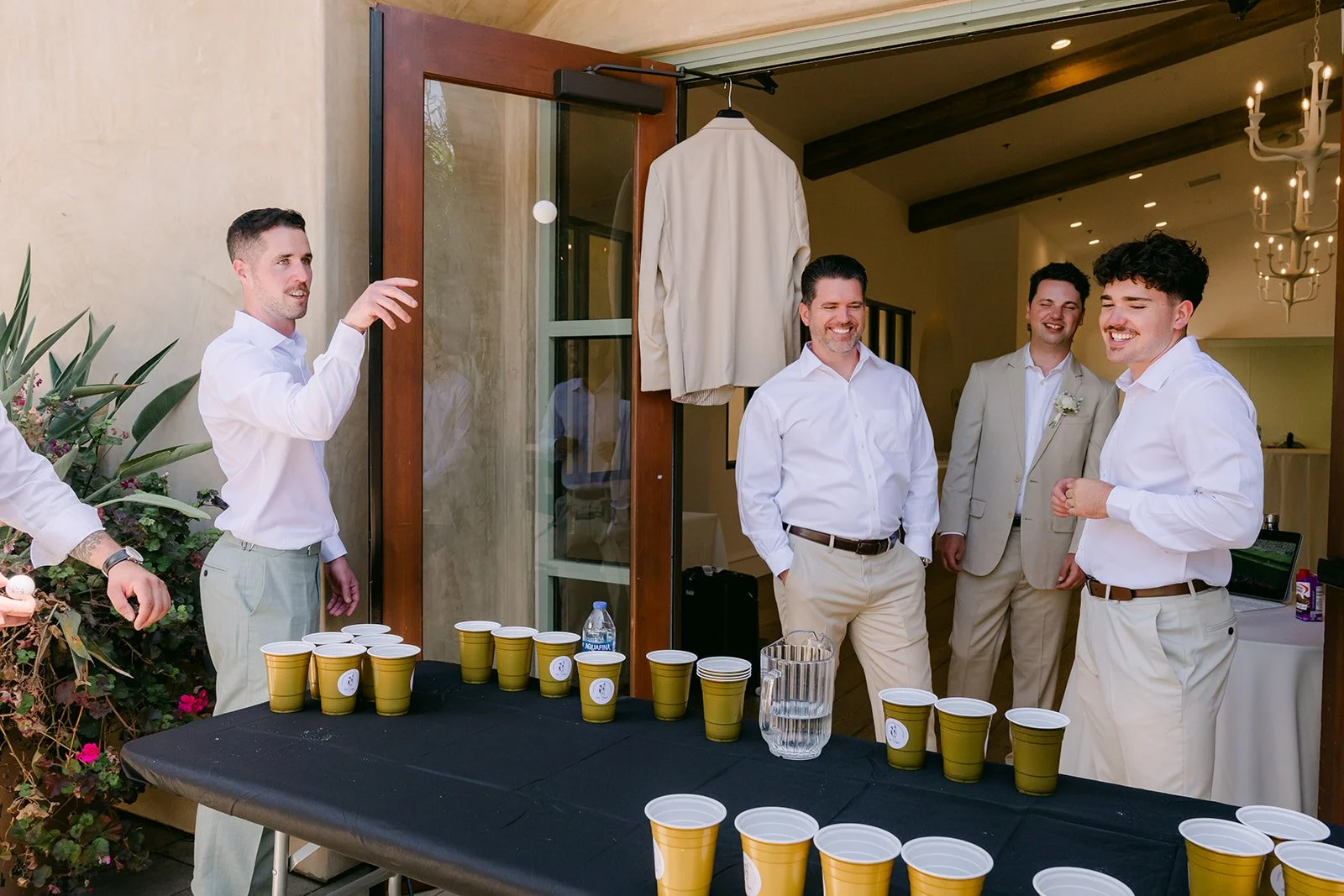 Groom and groomsmen playing beer pong at Serra Plaza
