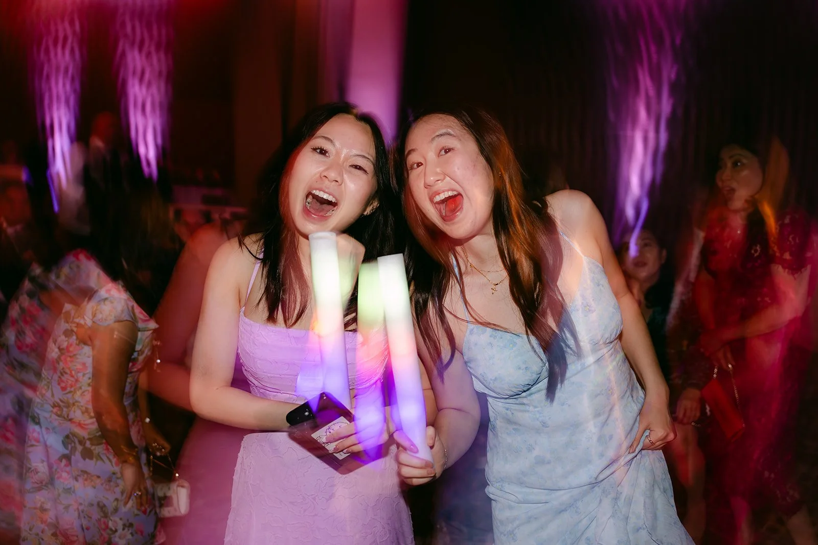 Bridesmaids dancing with light-up foam sticks