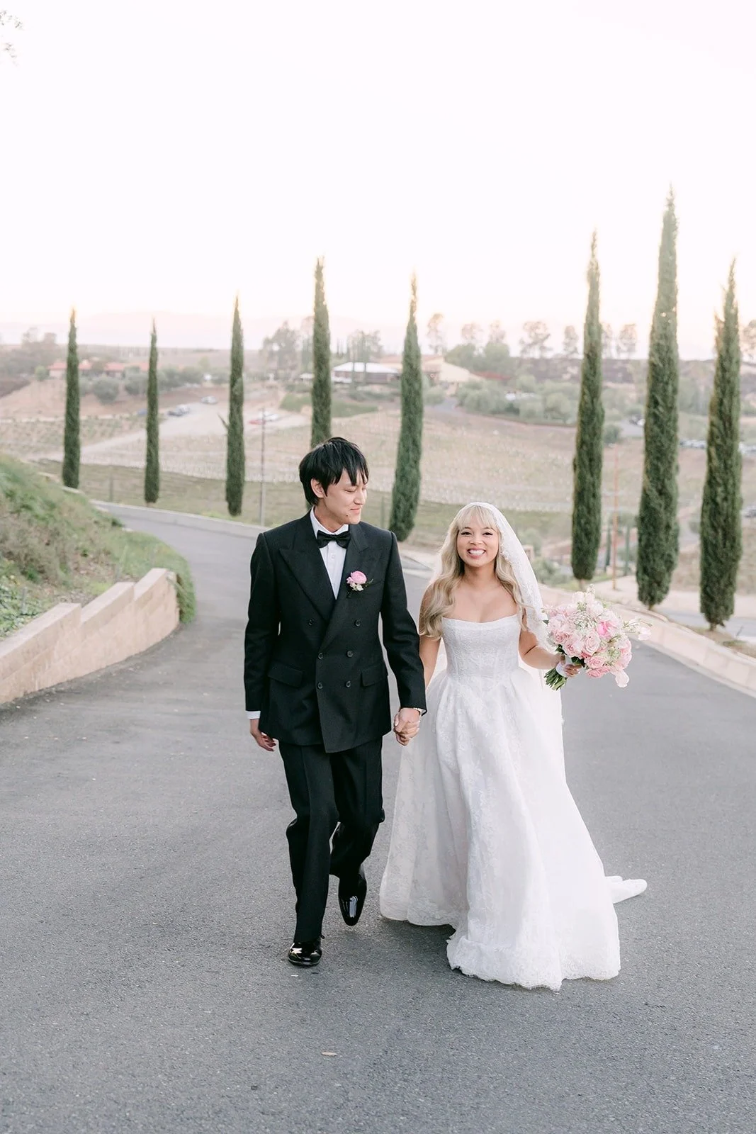 Konitha and Job walking hand in hand down the cypress drive