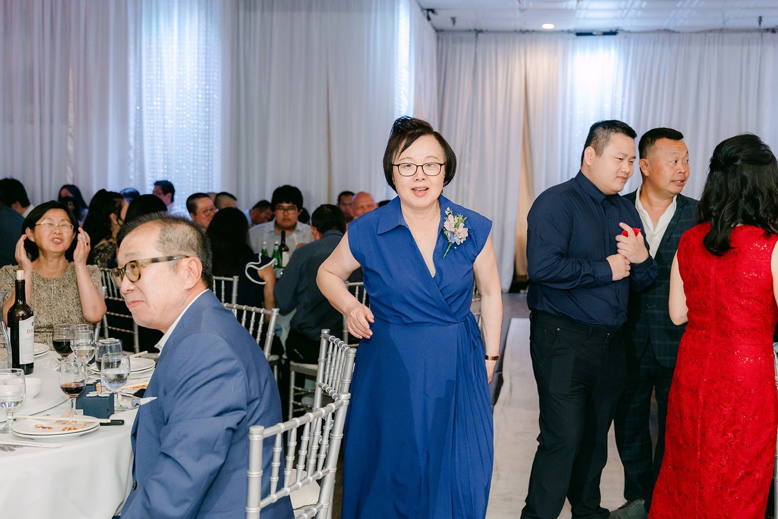 Family watching from their tables as the parent dances begin