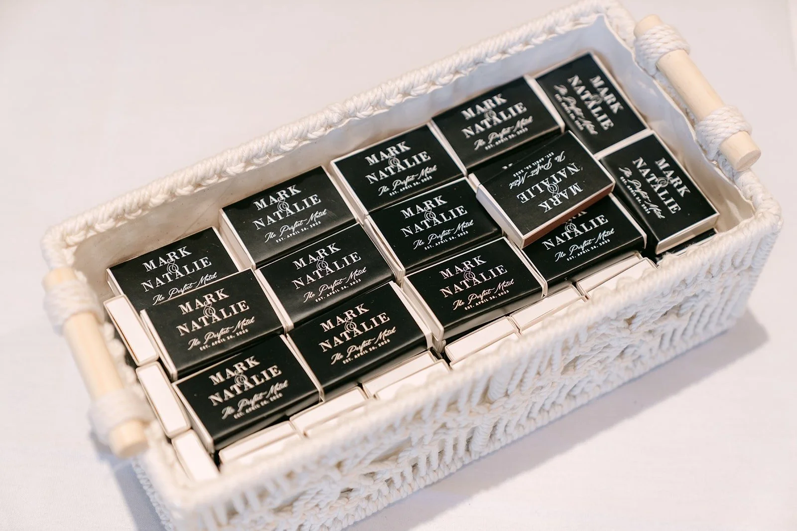 A basket of black matchbook favors for guests