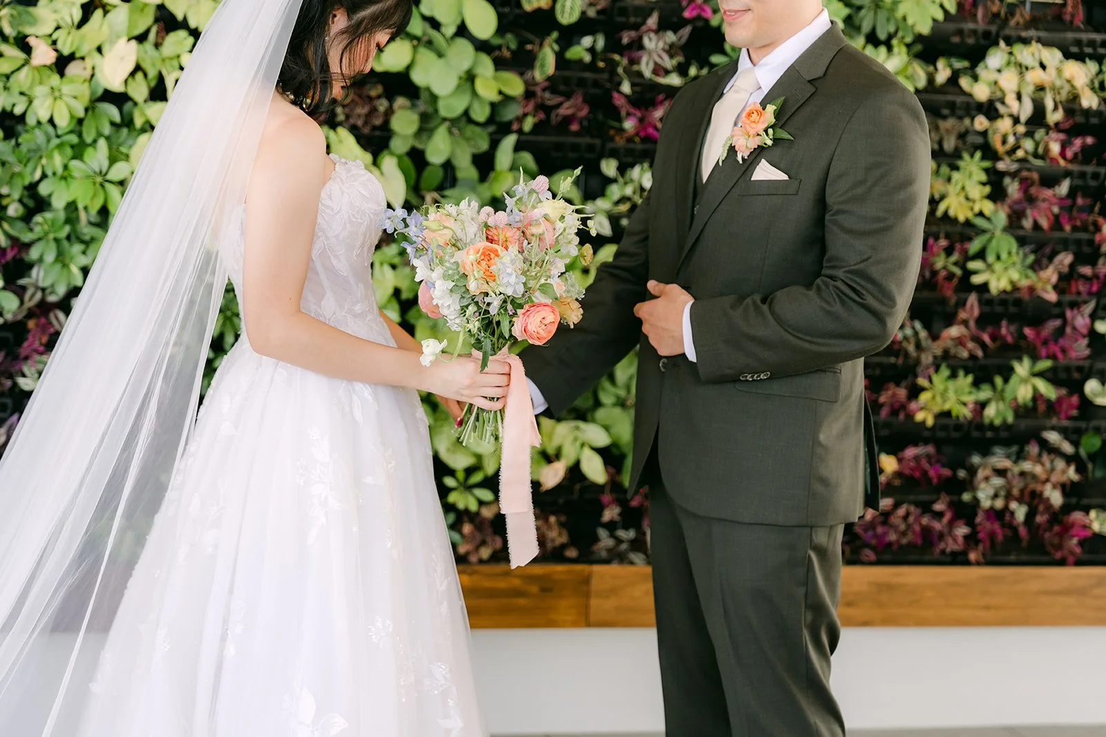 Alex looking at Vivian and her bouquet