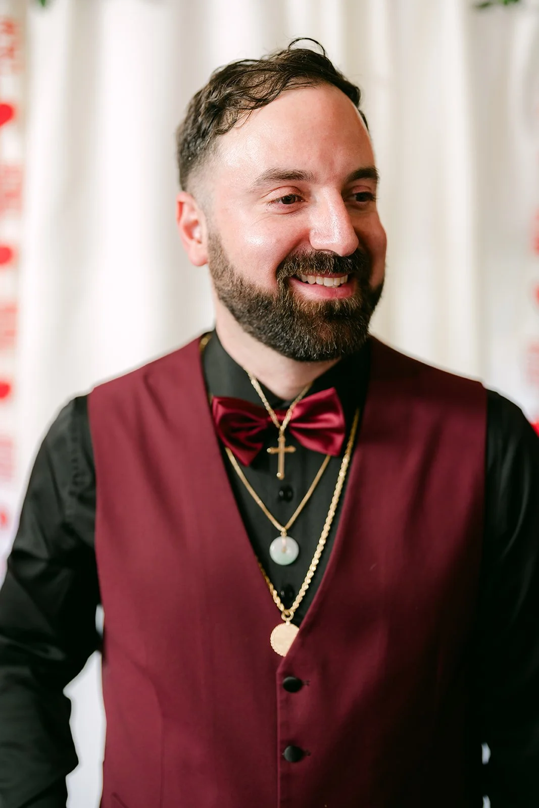 Ryan laughing in his burgundy vest.