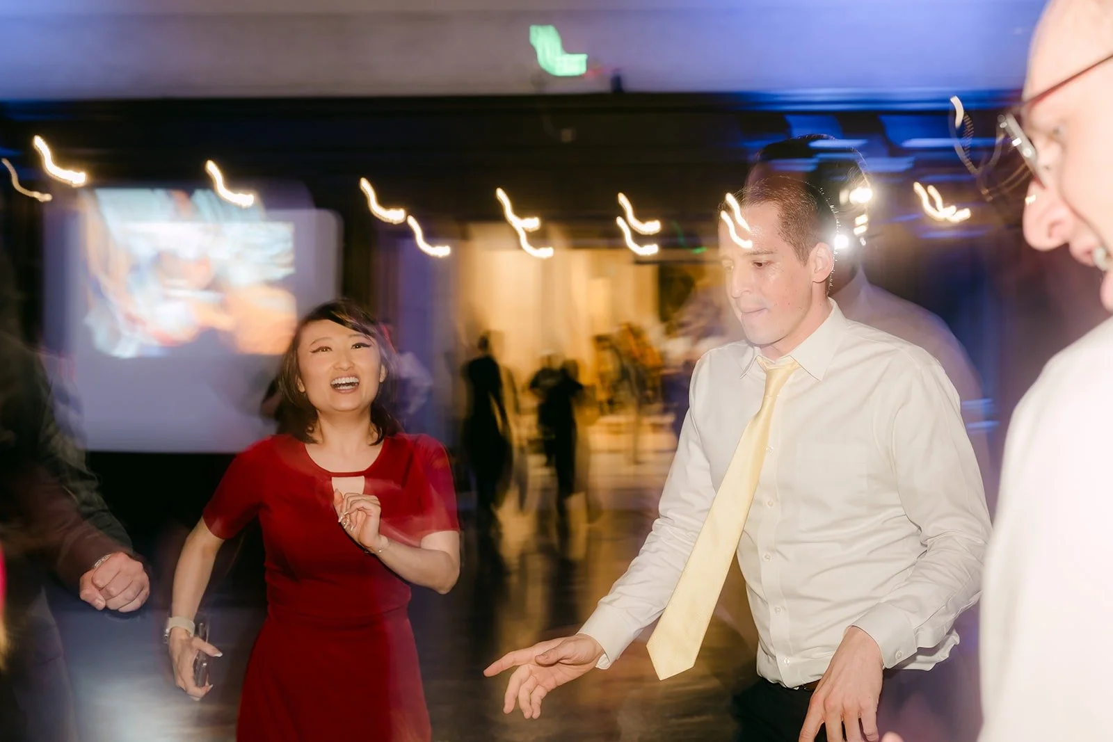 Guests dancing in a beam of light