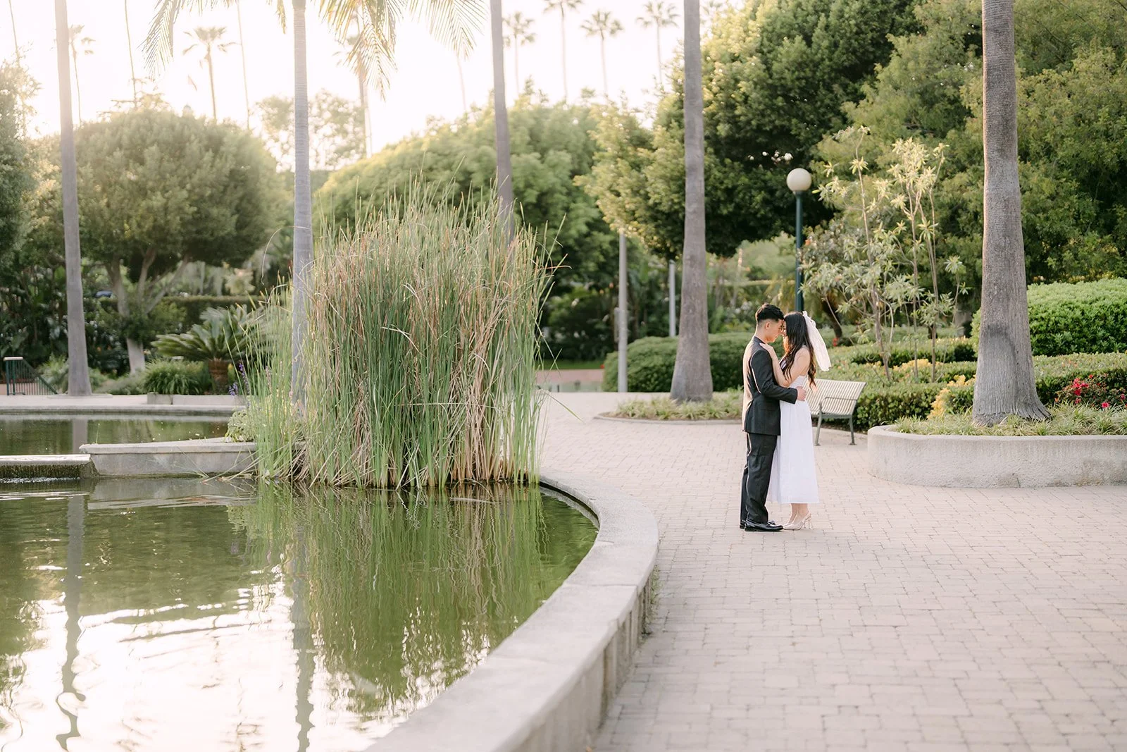 Jadee and Richard stand at the edge of the pond.