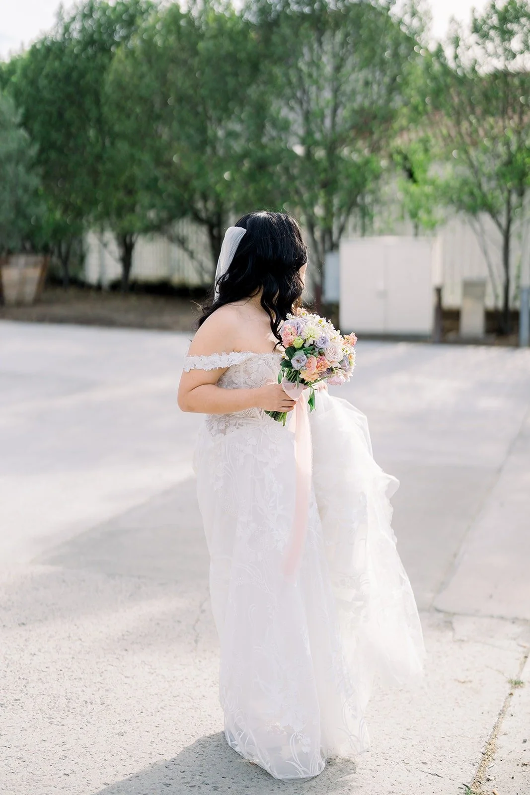 Francesca walking outside the hotel in her gown and veil, photographed by One and Only Production