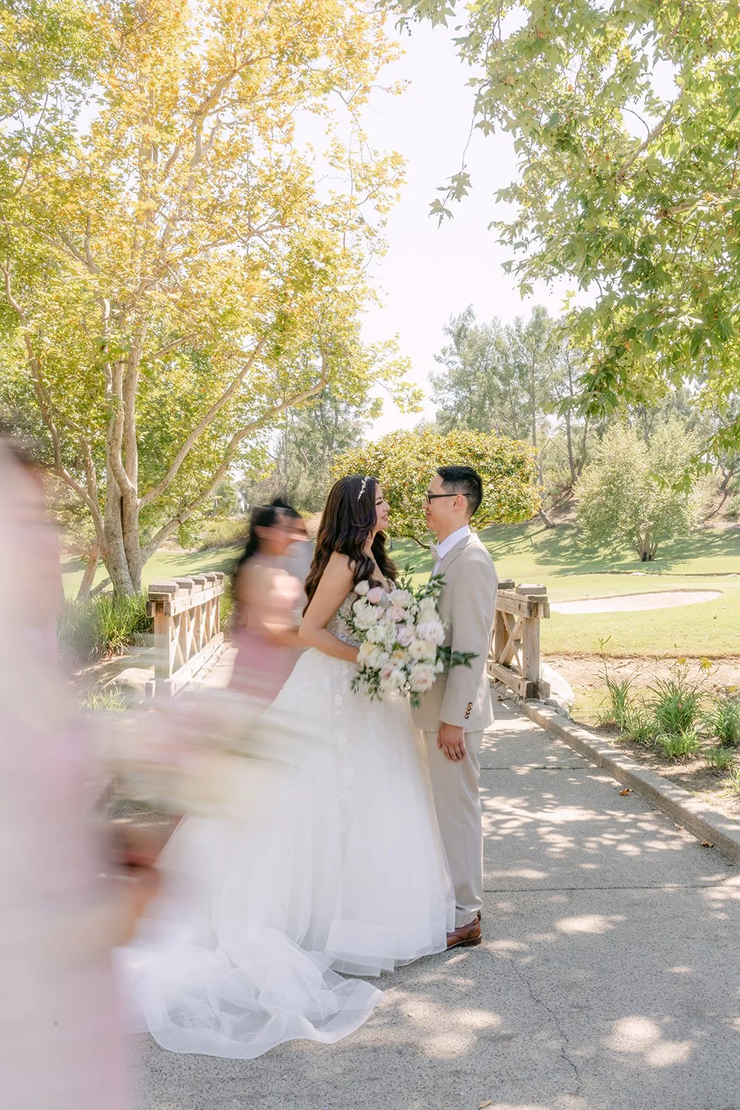 Sandra and Kevin walking along the path with their bridal party.