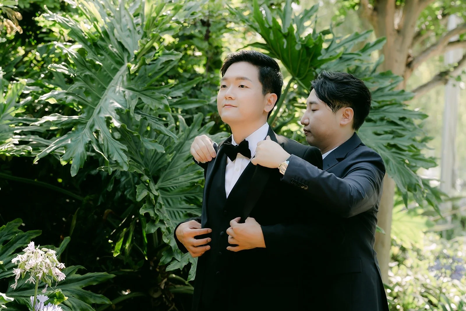 Eunsang's jacket being straightened before the ceremony