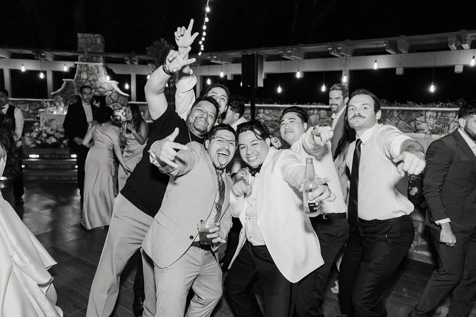 Black and white photo of guests celebrating on the dance floor