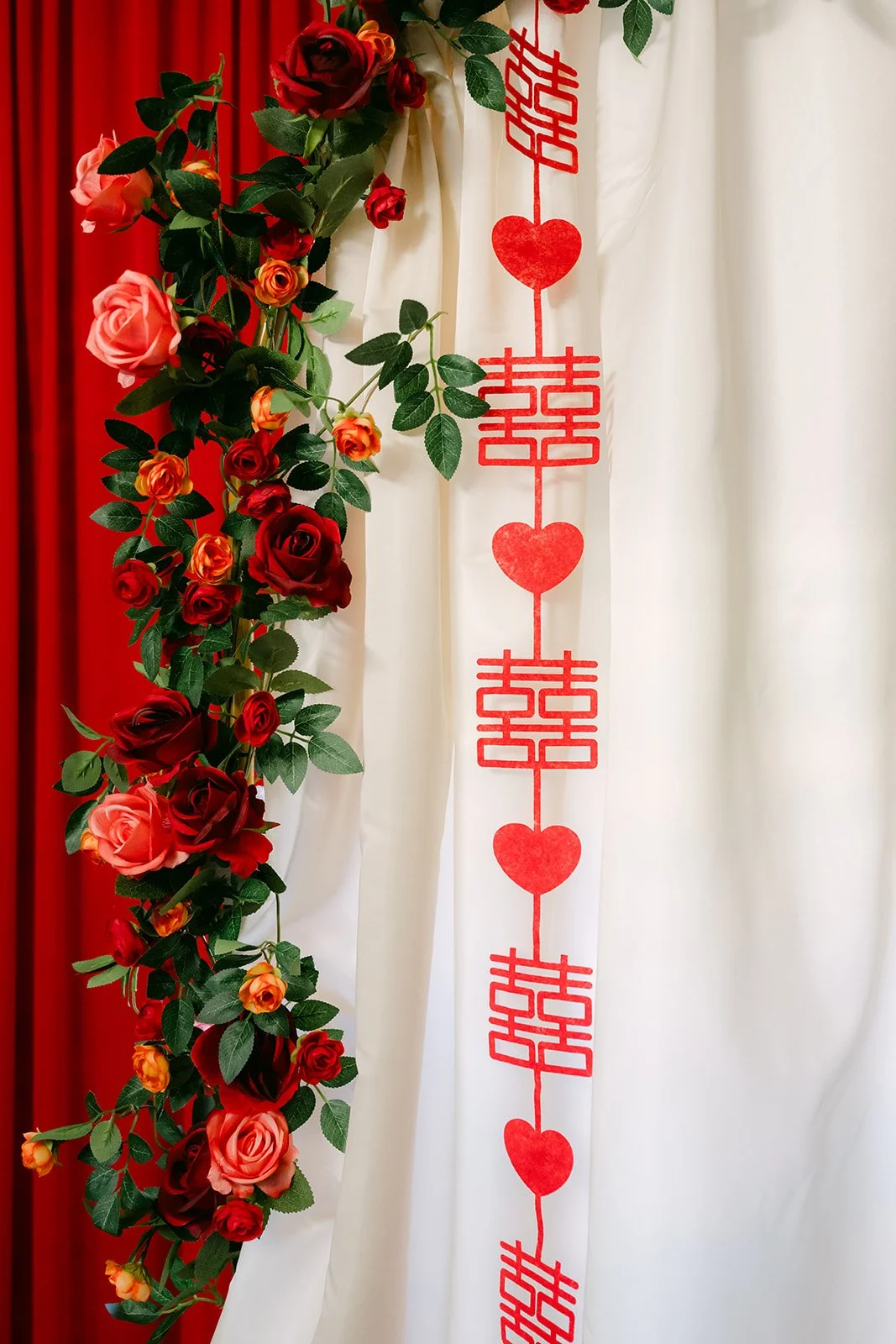 Floral garland with red double happiness hearts.