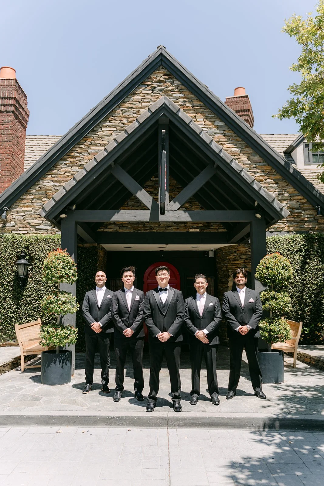Joshua and his groomsmen in front of the manor