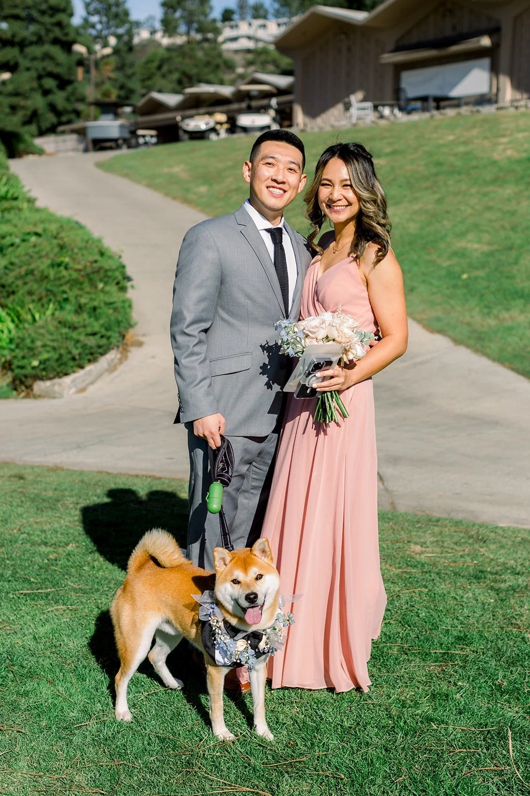 Two guests with Josephine and David's dog in a bow tie before the ceremony