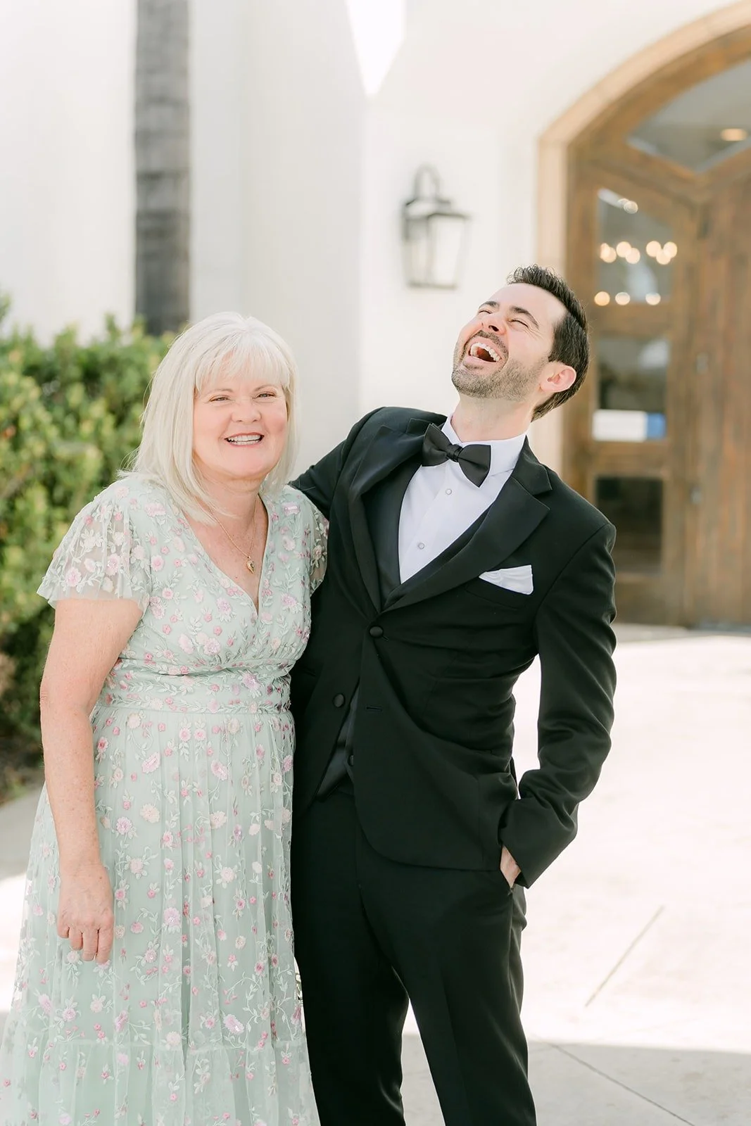 Kevin laughing beside his mom after their first look
