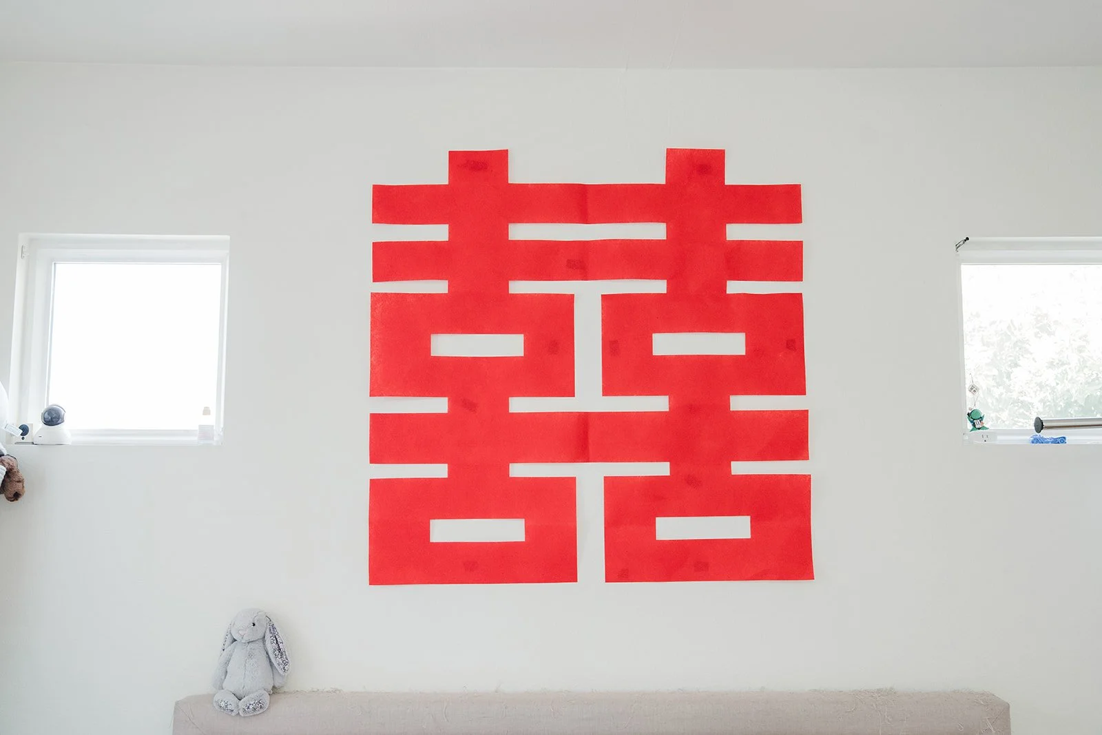 A large double happiness papercut on the wall.