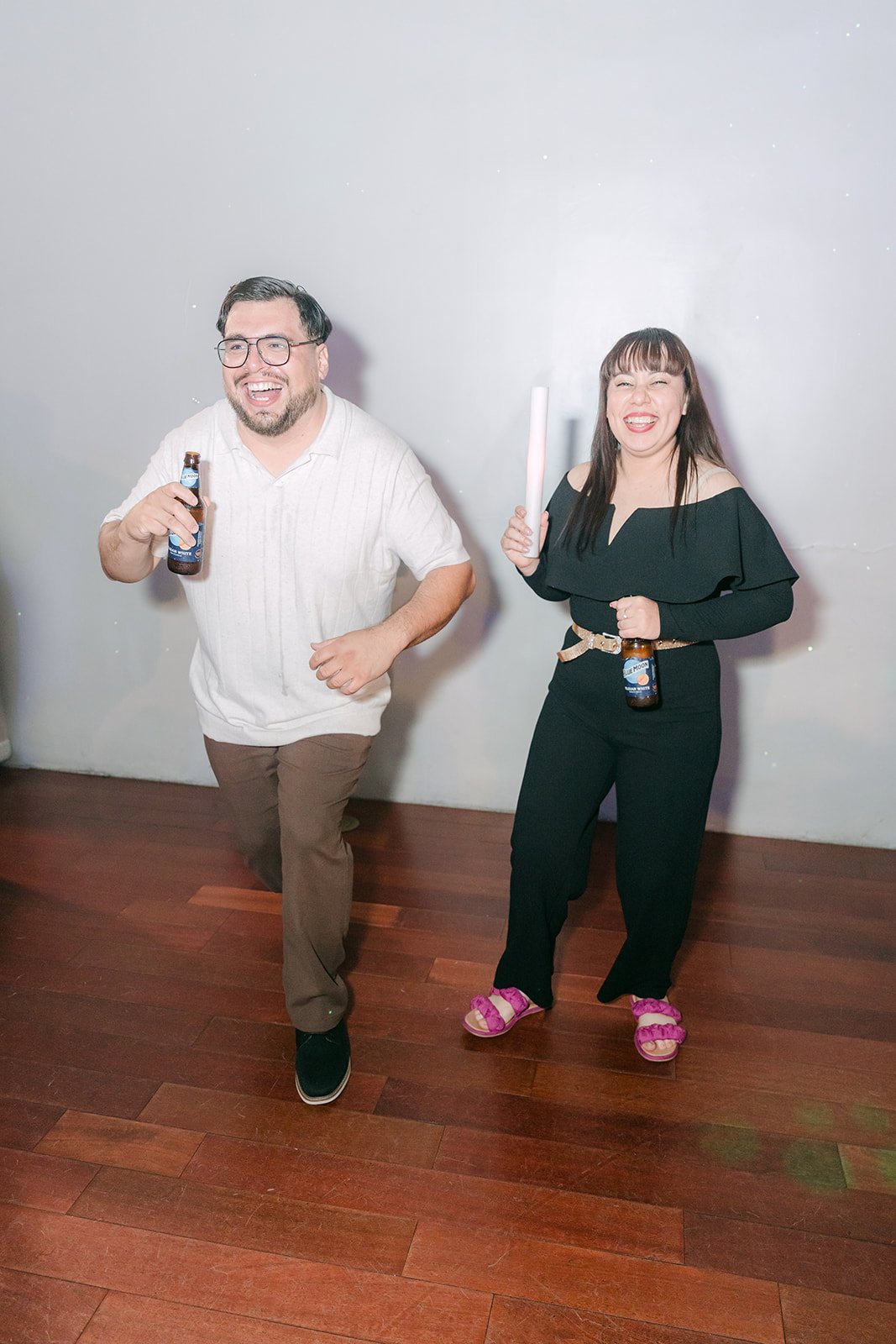 Two guests dancing with glow sticks
