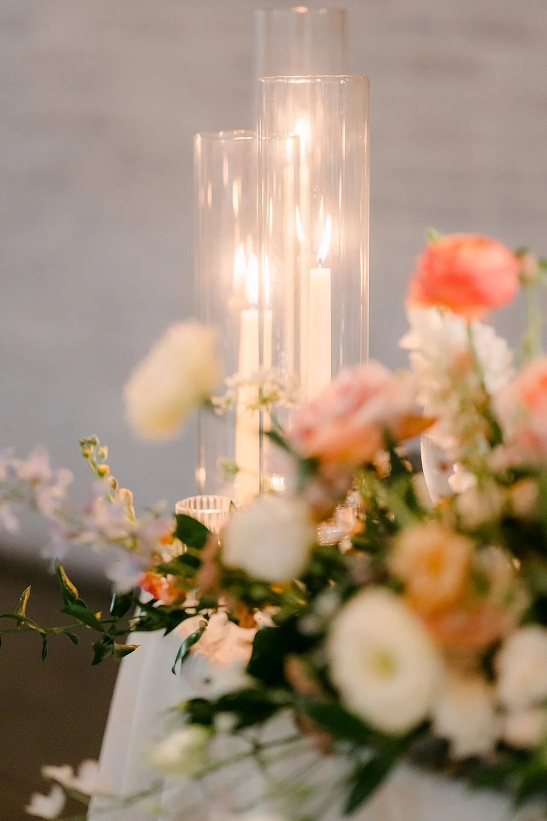 Candles glowing beside pastel florals