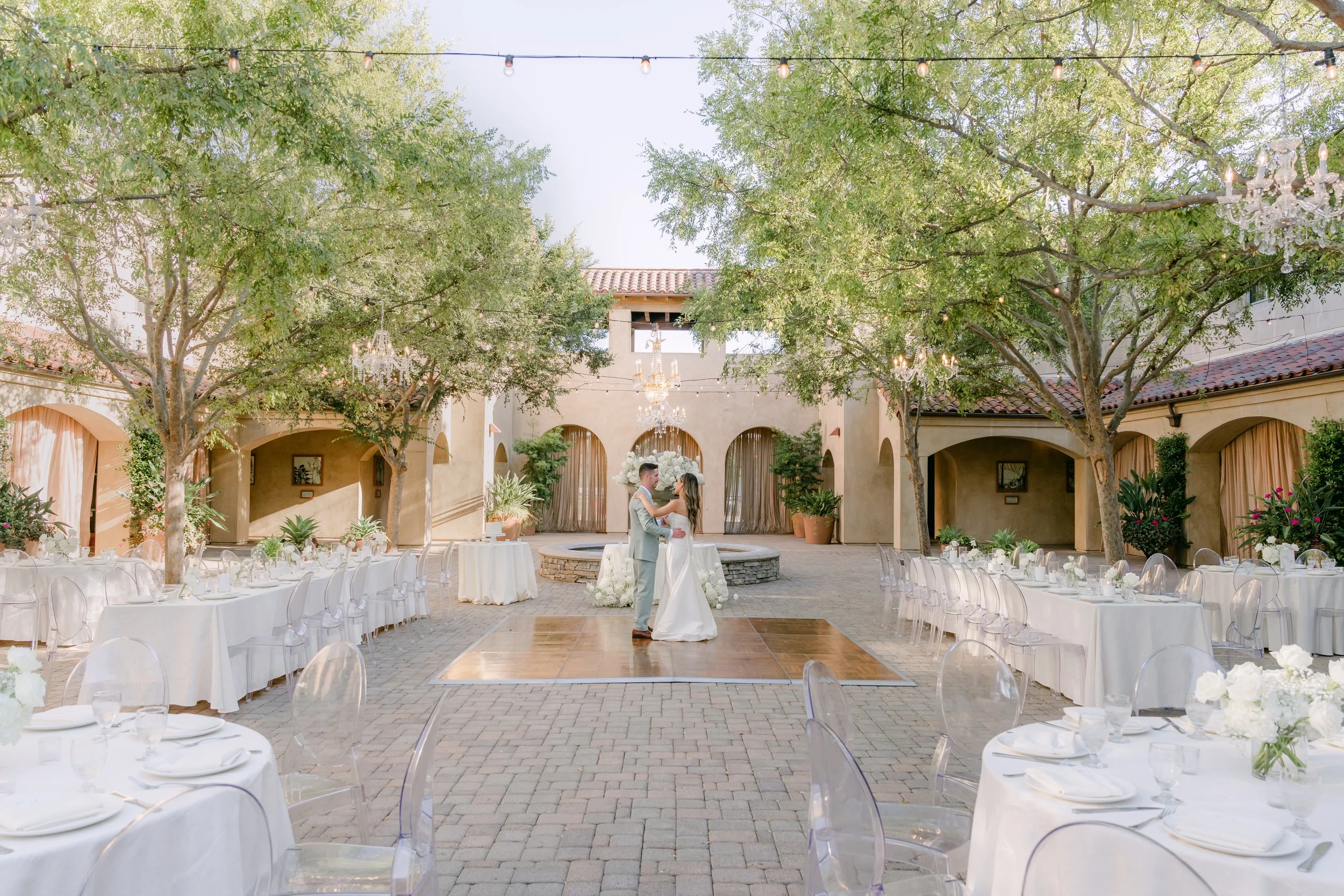 Courtyard reception set beneath the trees at Serra Plaza in San Juan Capistrano