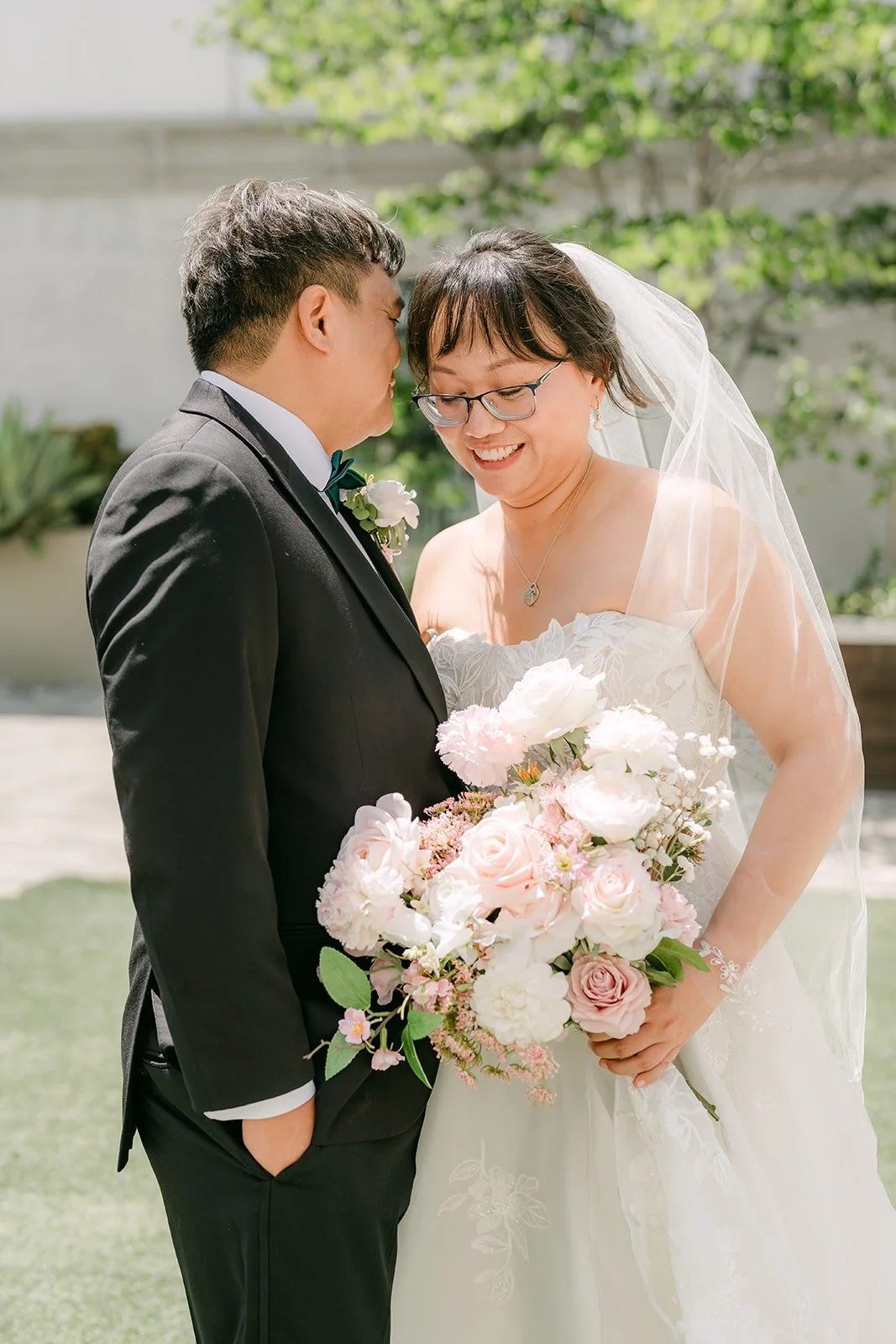Stella laughing with her eyes closed as James leans in beside her