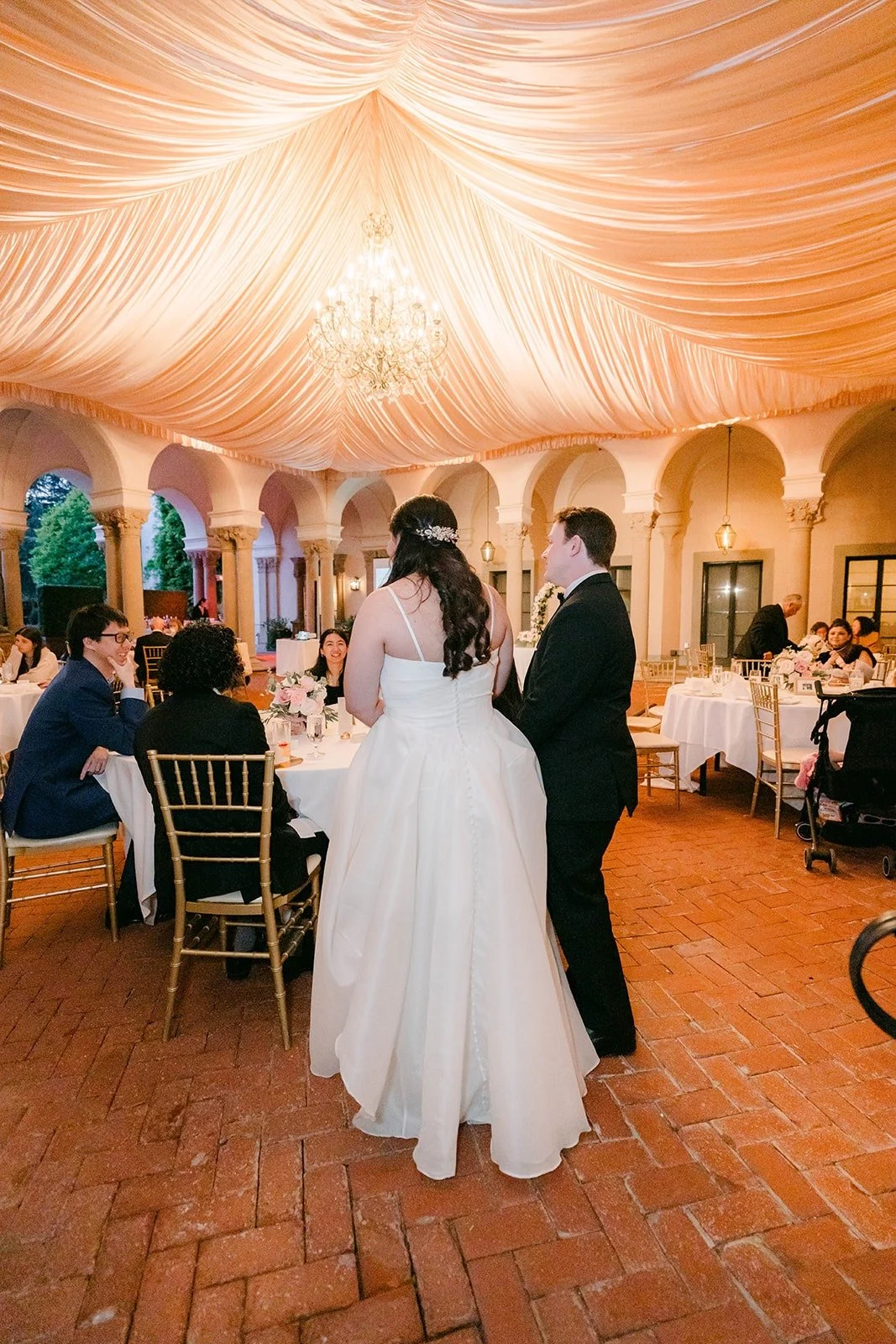 Saira and Matthew greeting tables during dinner